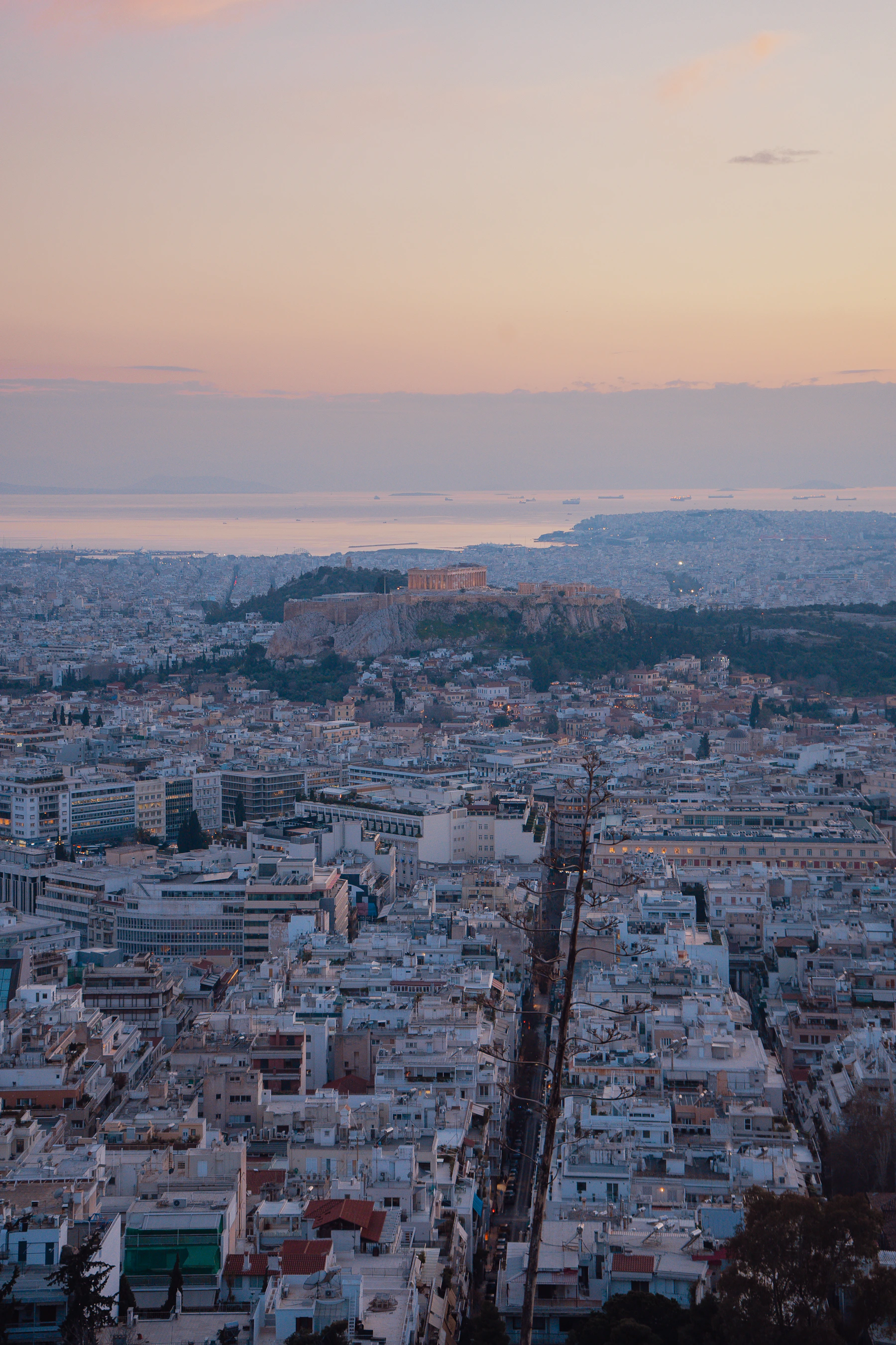 Athens spreading around the illuminated Acropolis in the warm light of sunset