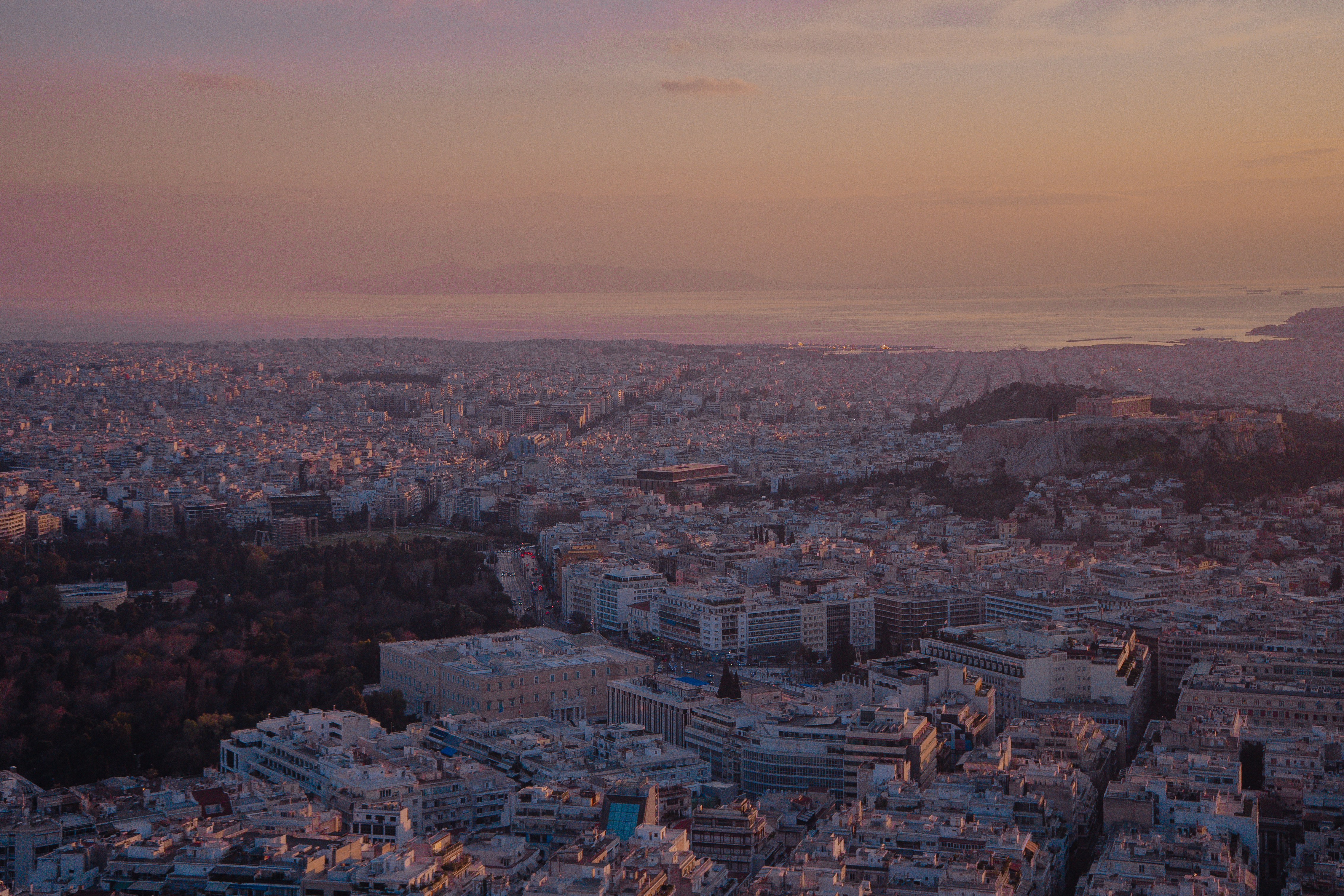 Aerial view of a sprawling city at sunset