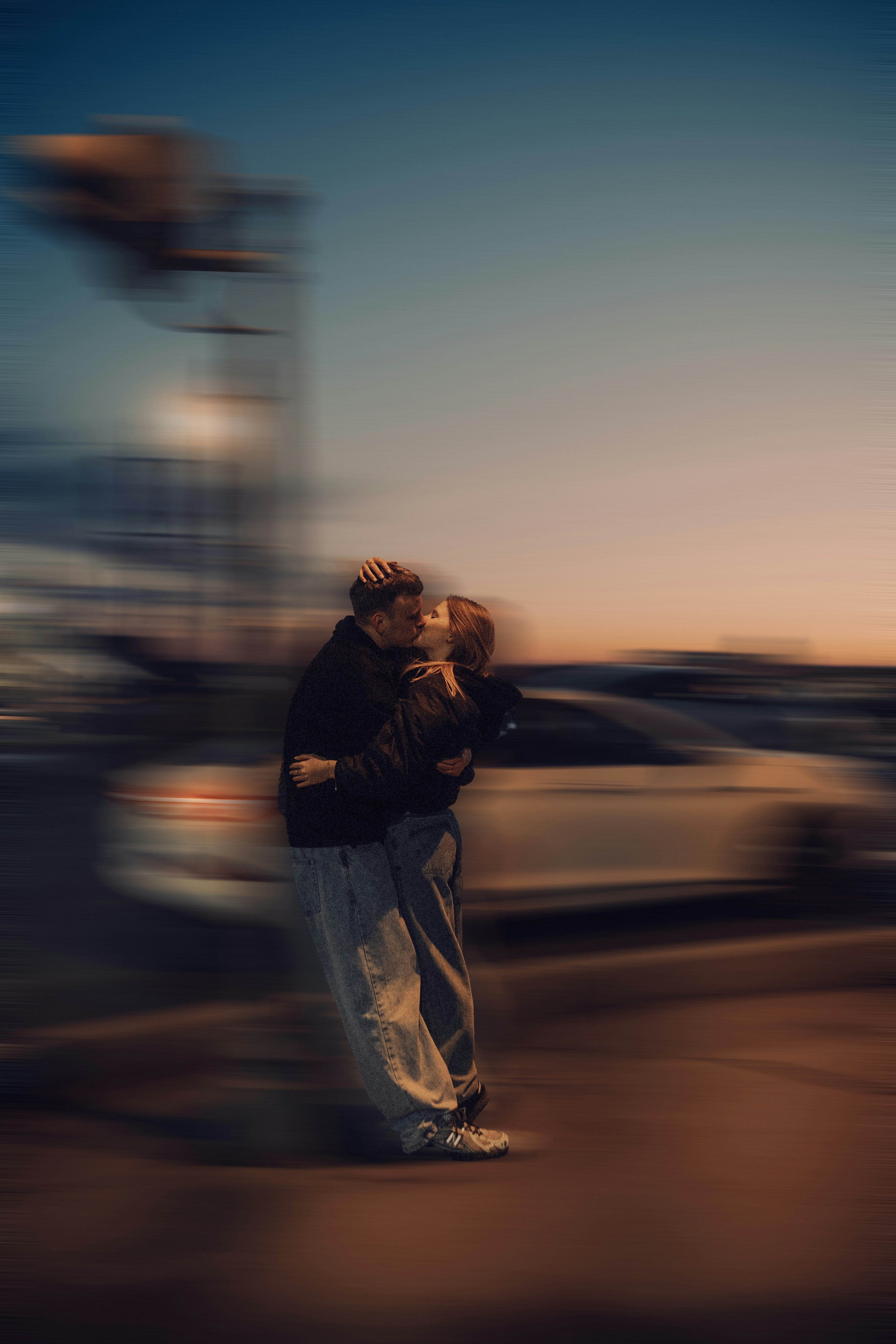 Couple kissing passionately at dusk with motion blur