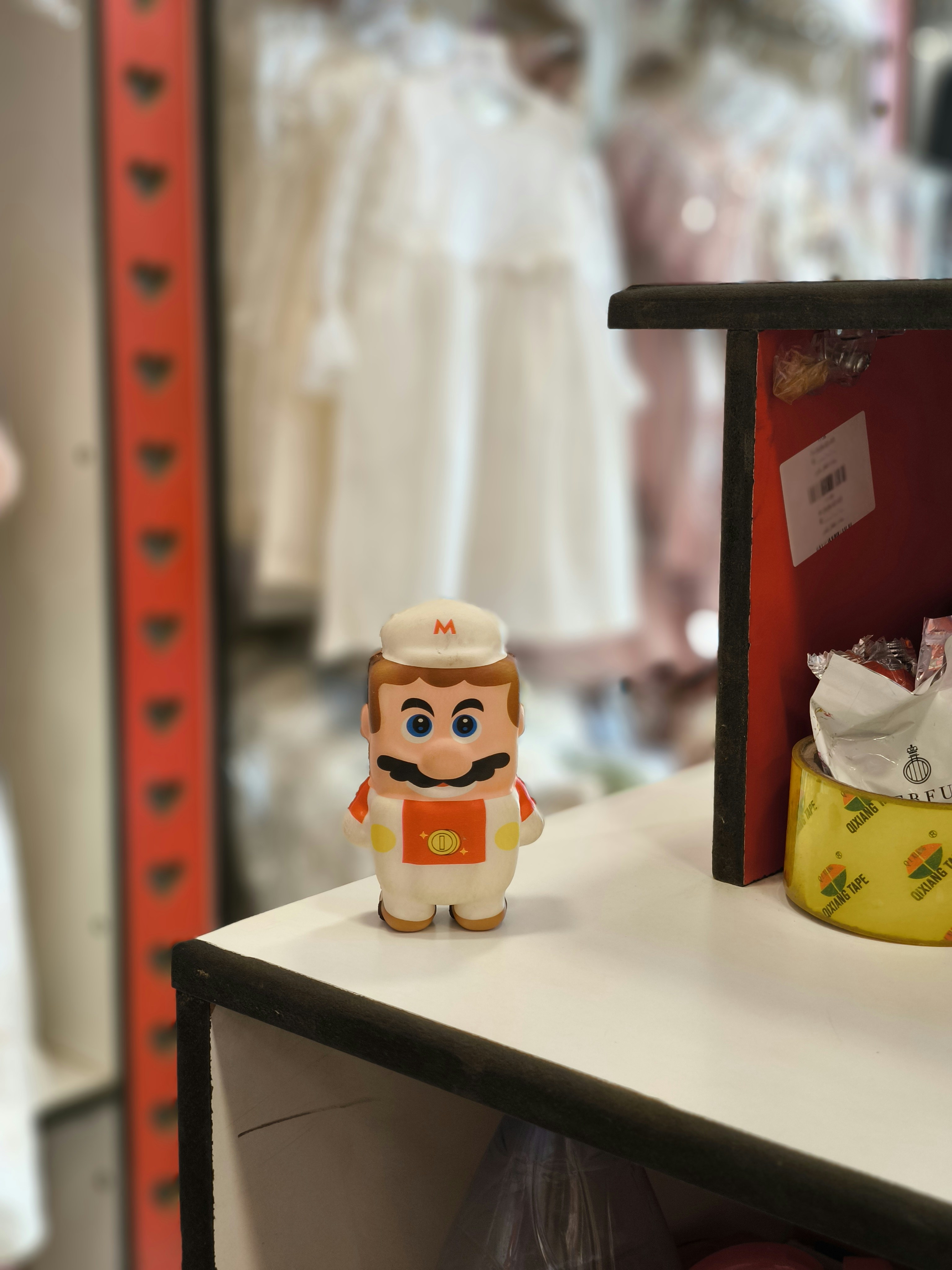Mario figurine on a shelf with blurred background
