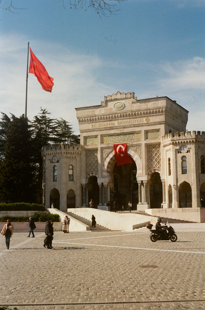 University entrance gate with a Turkish flag