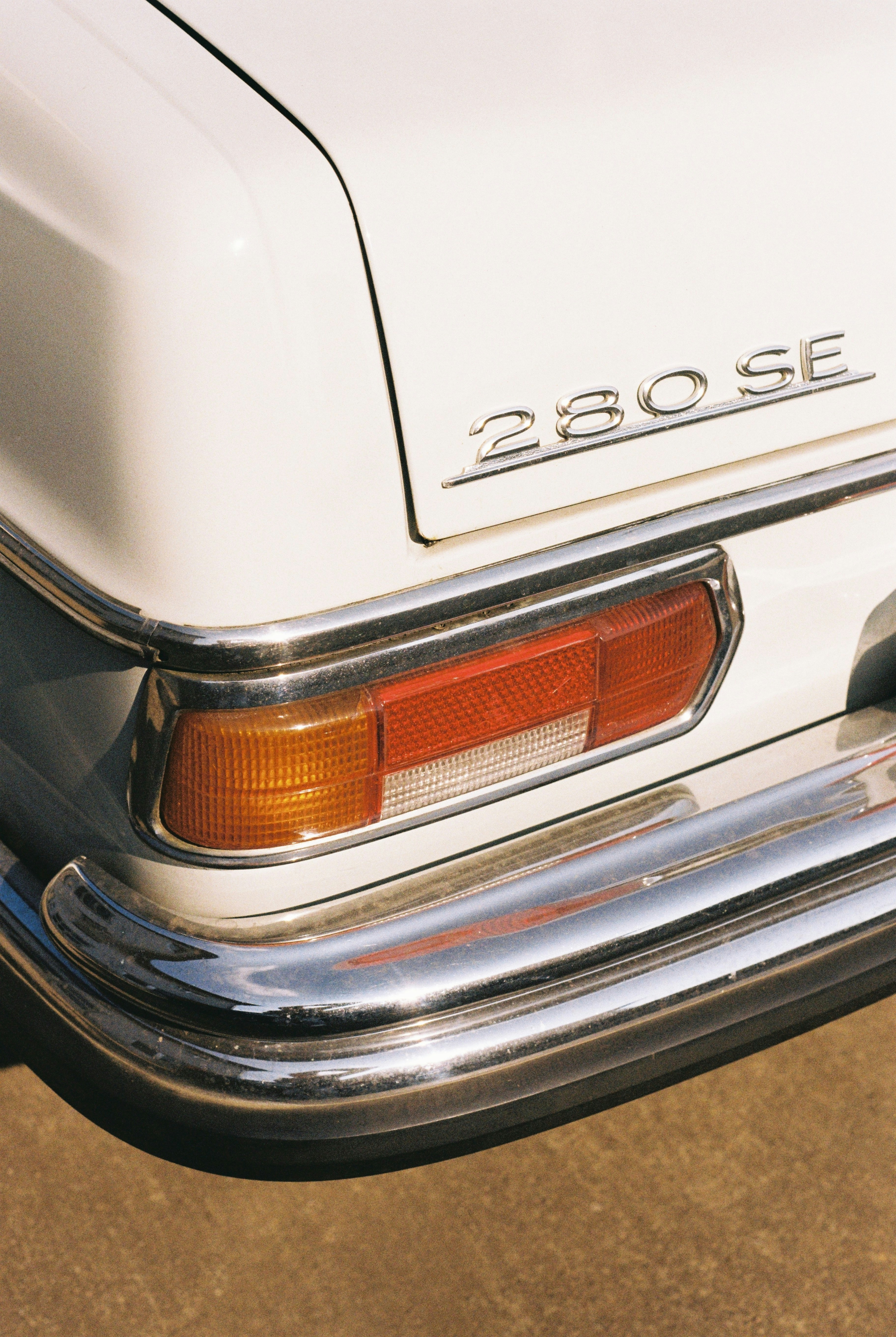 Close-up of a white vintage mercedes 280 se car.