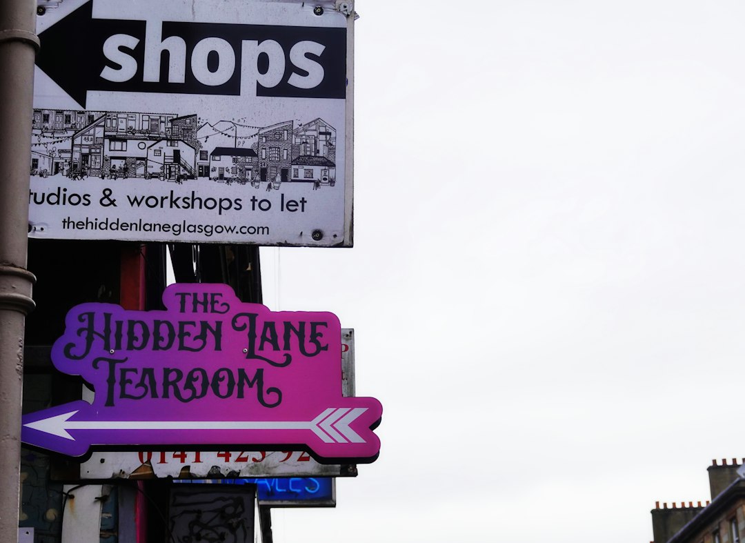 Signs for shops and the hidden lane tearoom.