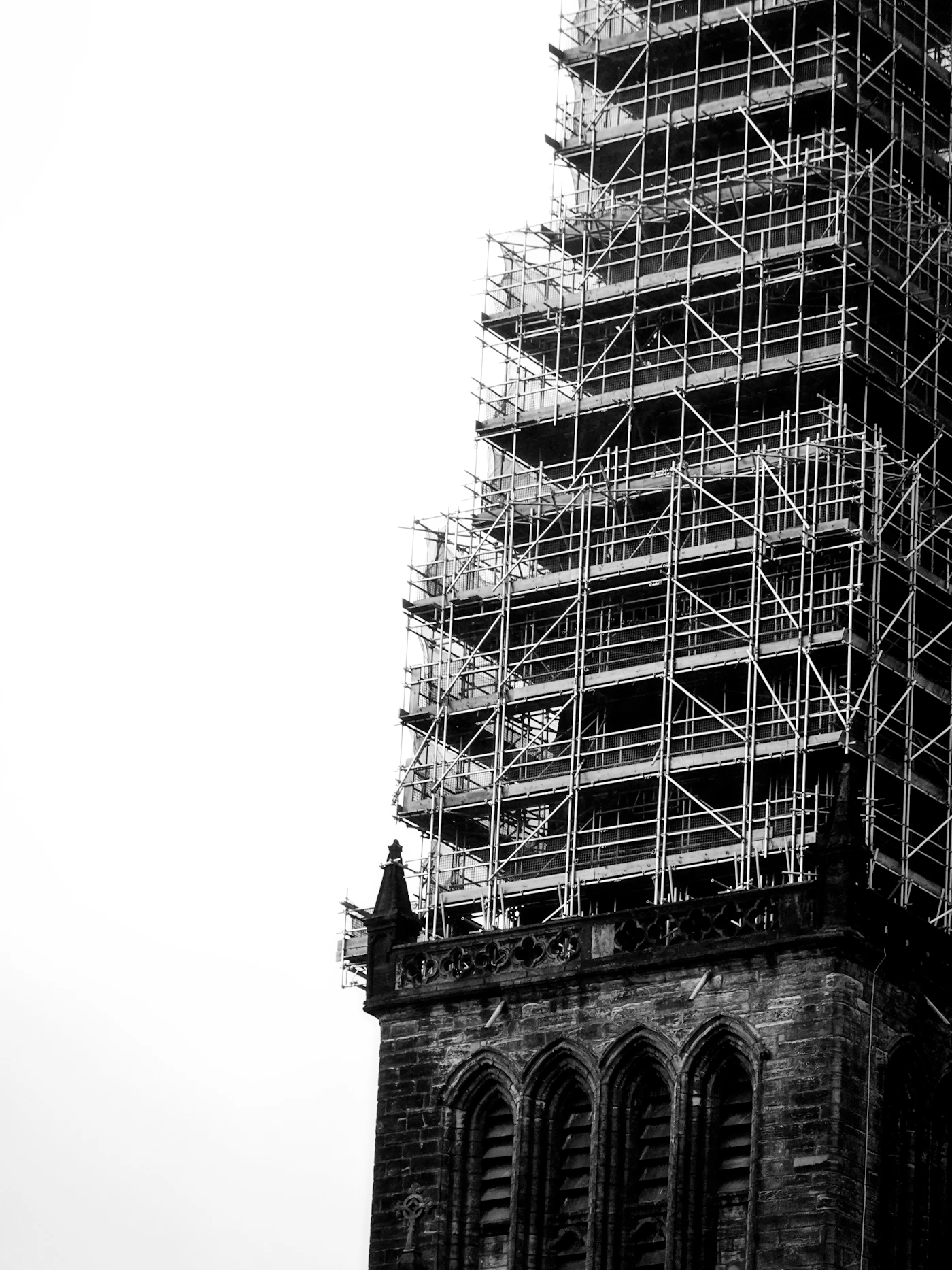 Historic stone tower surrounded by conservation scaffolding
