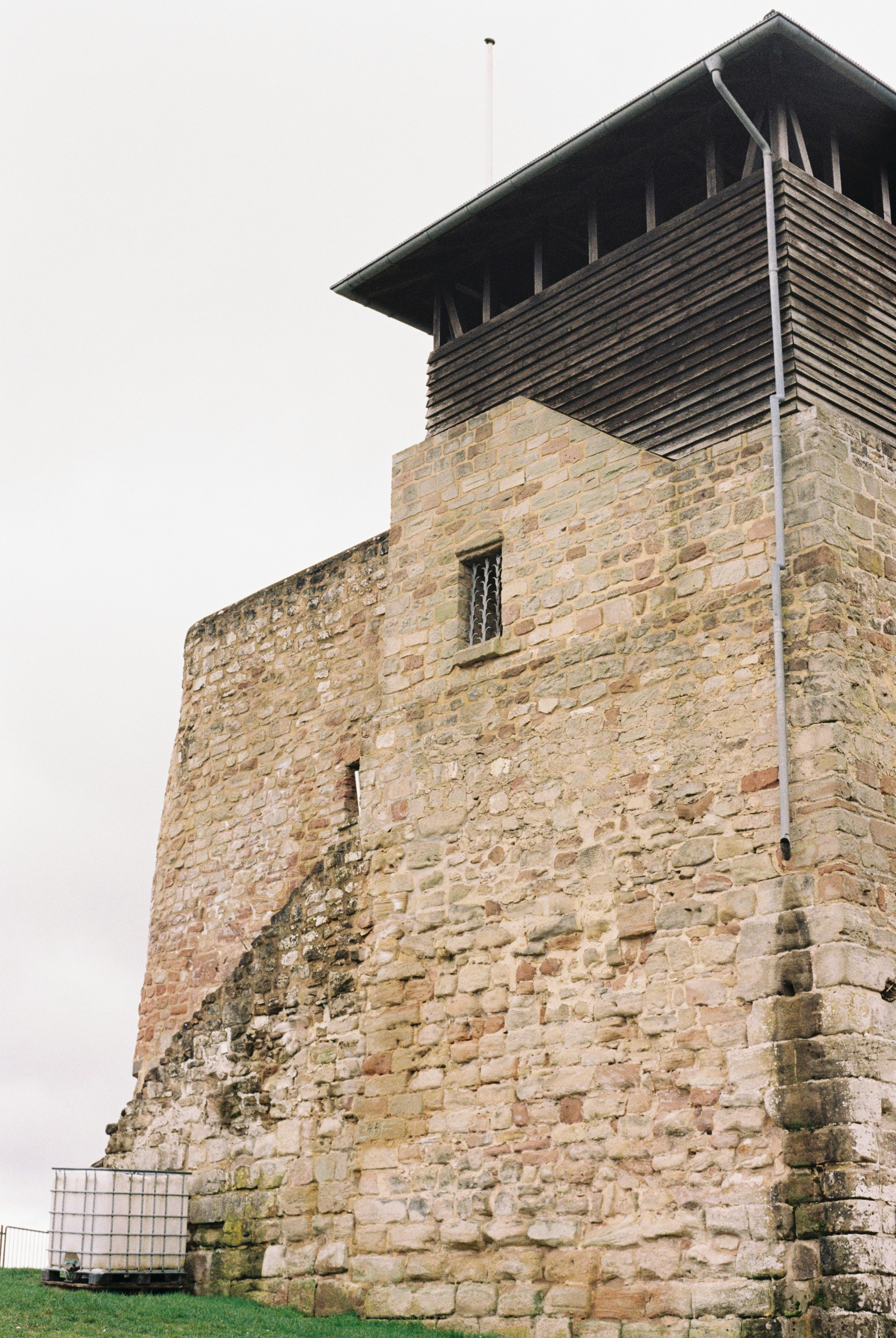 Stone tower with wooden upper section and small window