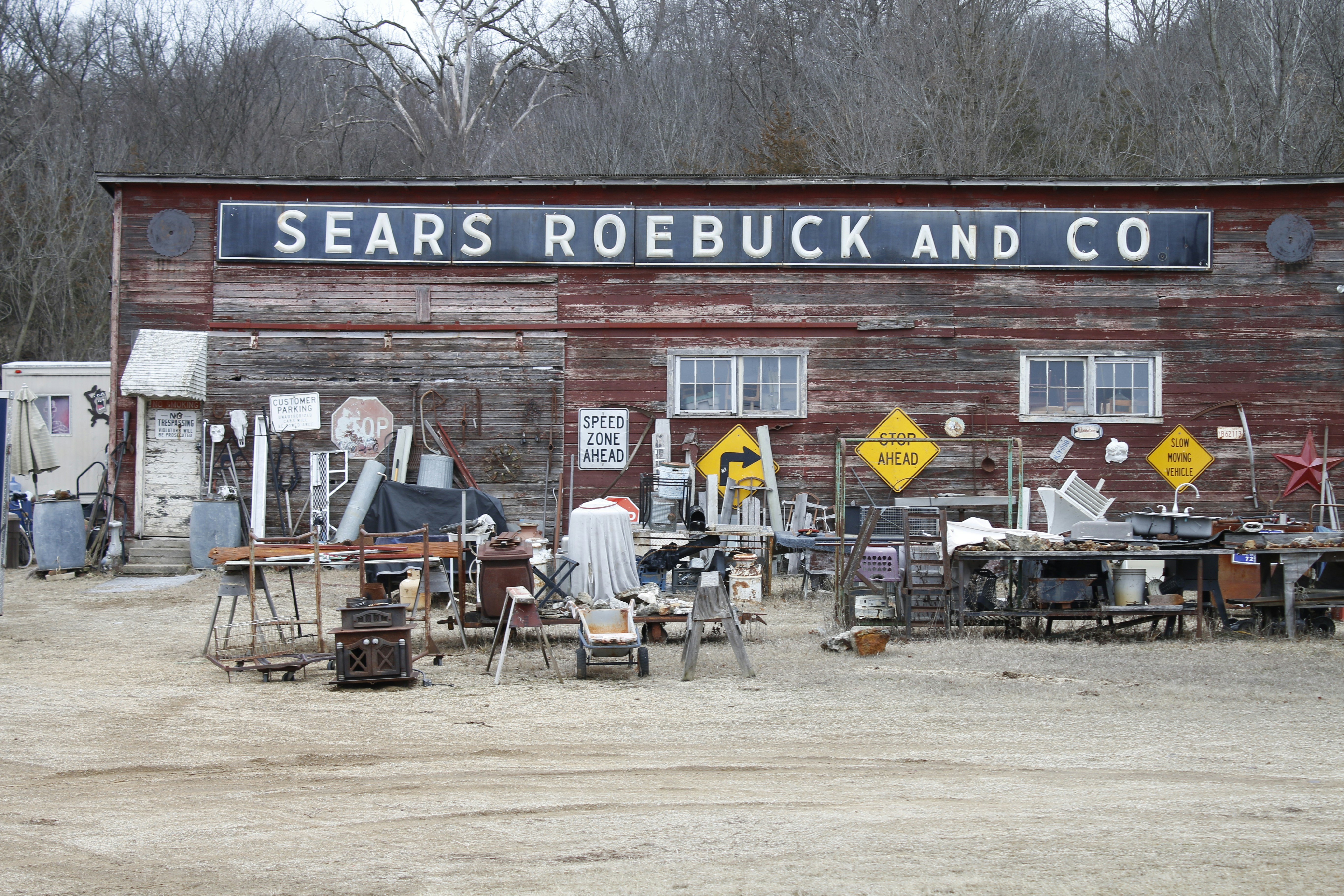 Old sears roebuck and co. building with junk outside.