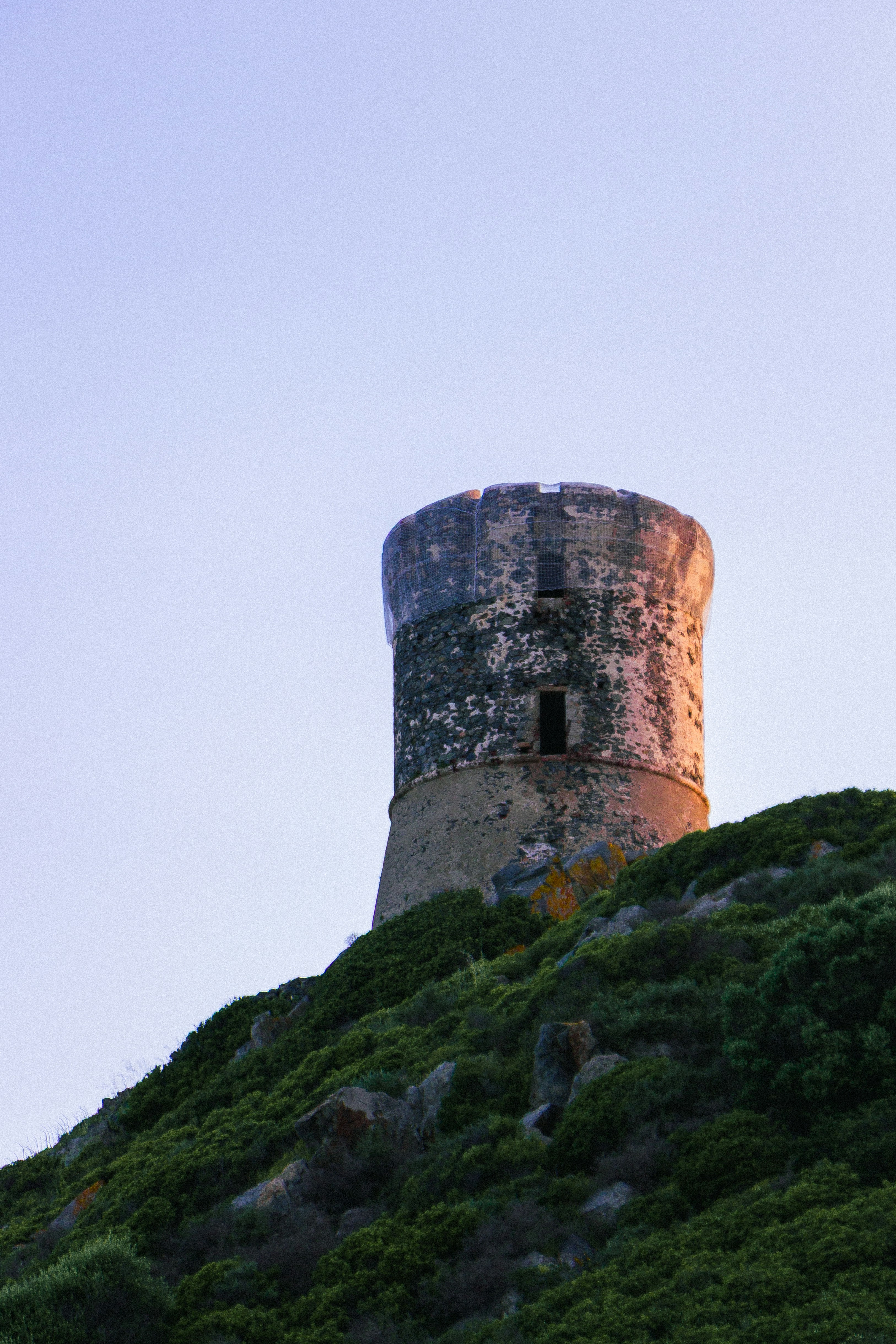 Ancient stone tower on a grassy hill