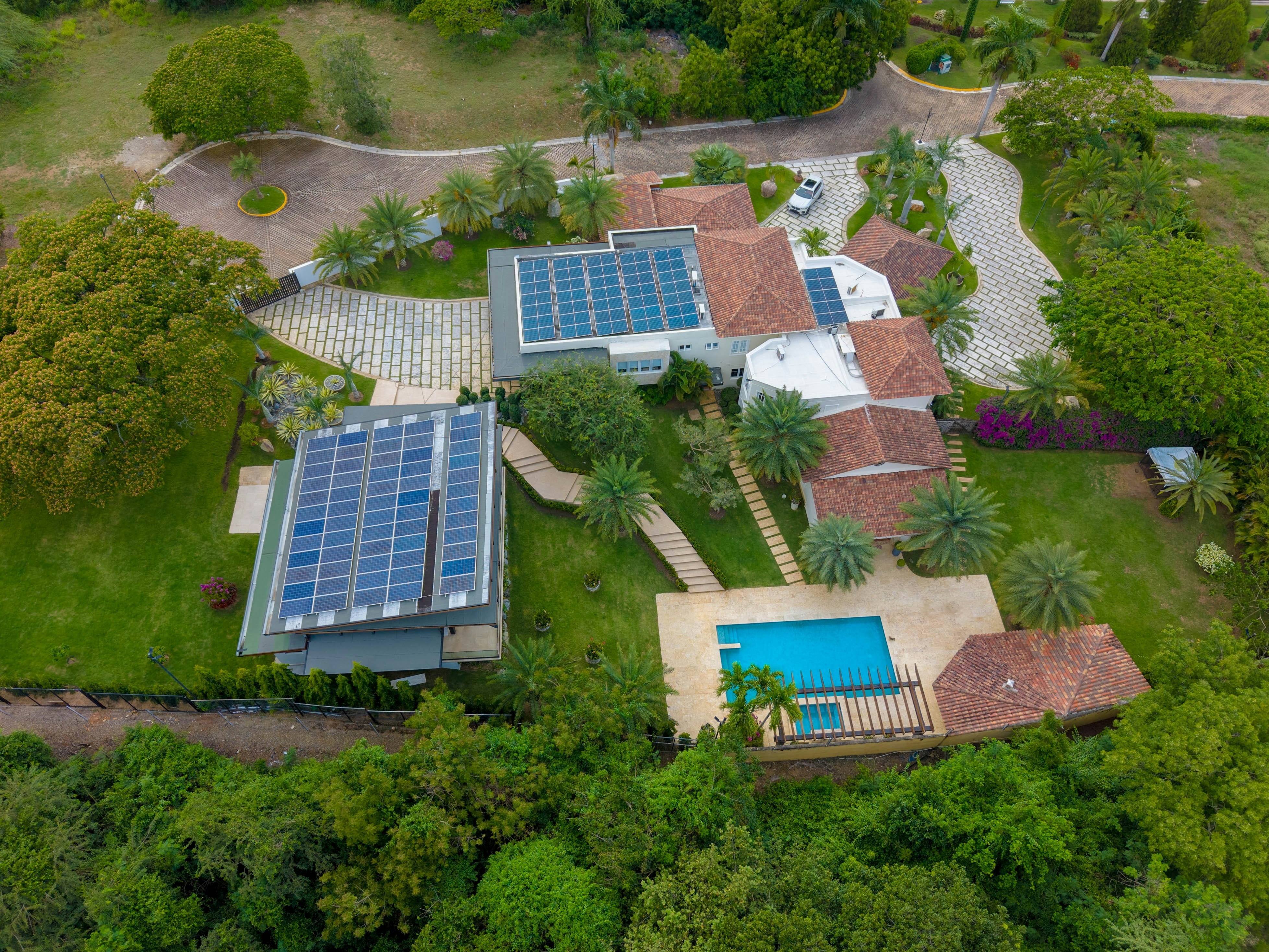 Modern house with solar panels and swimming pool.