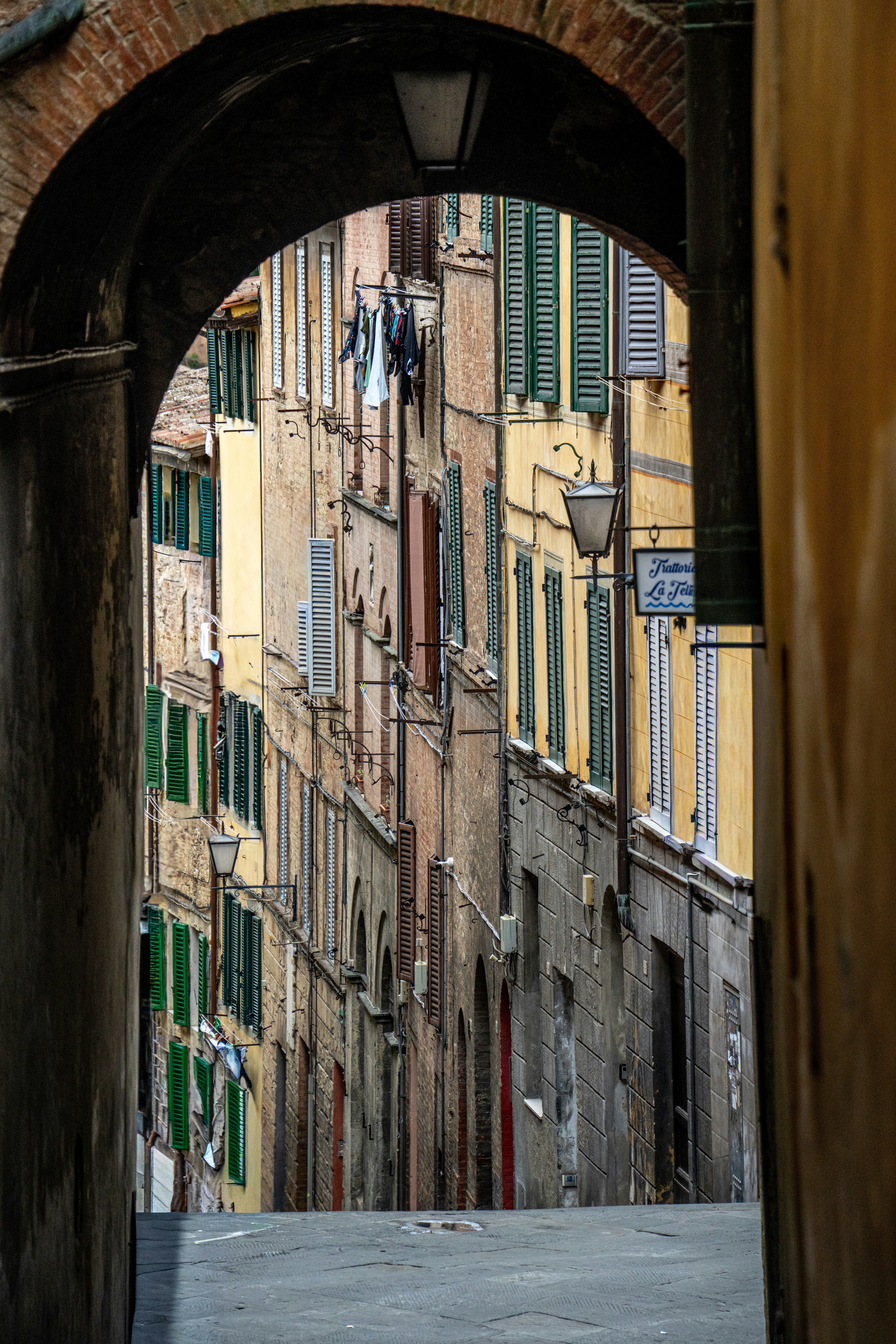 View through an archway of a narrow european street.