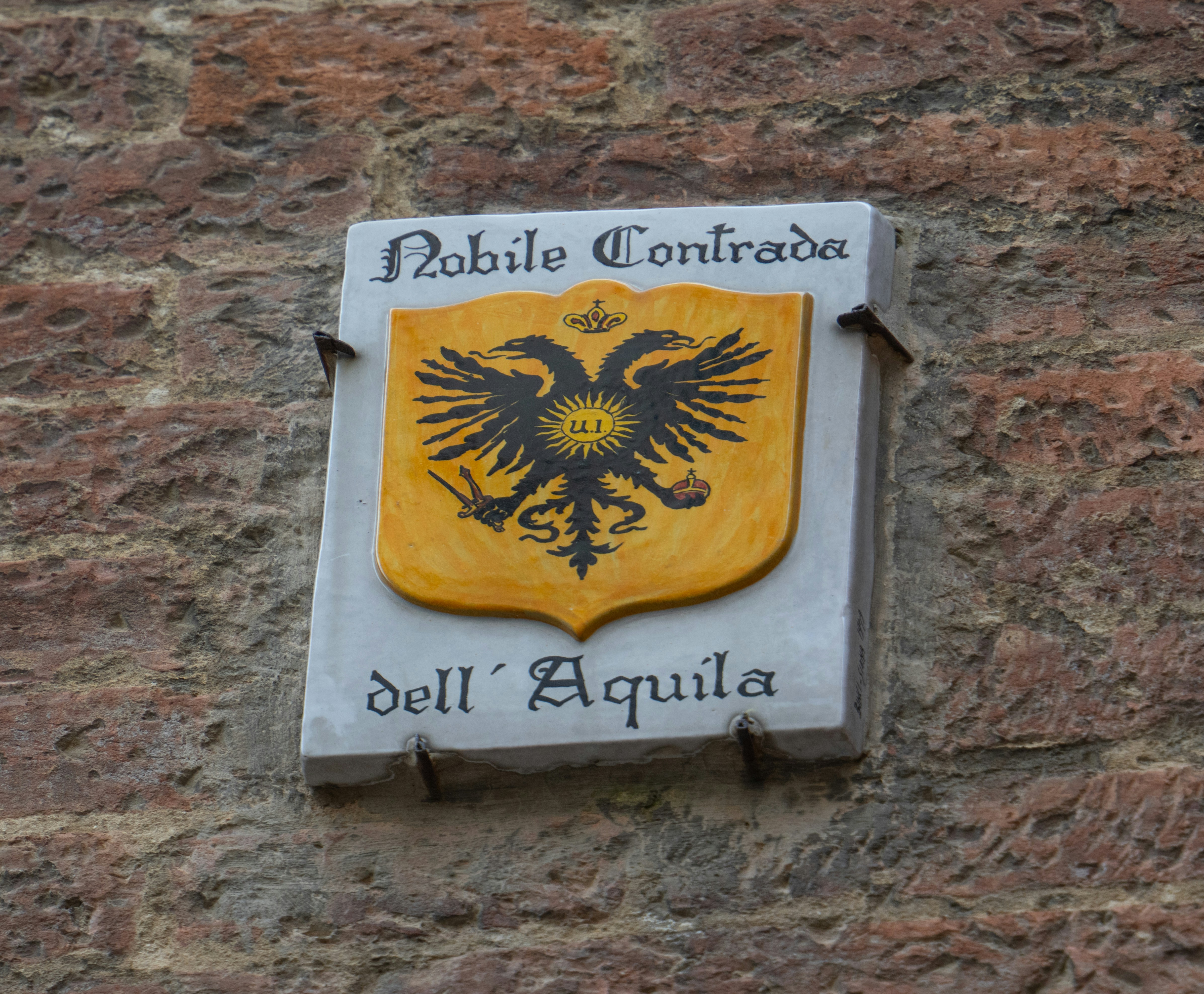 Coat of arms with double-headed eagle on brick wall