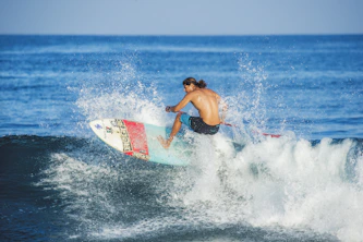 Surfer riding a wave, kicking up water