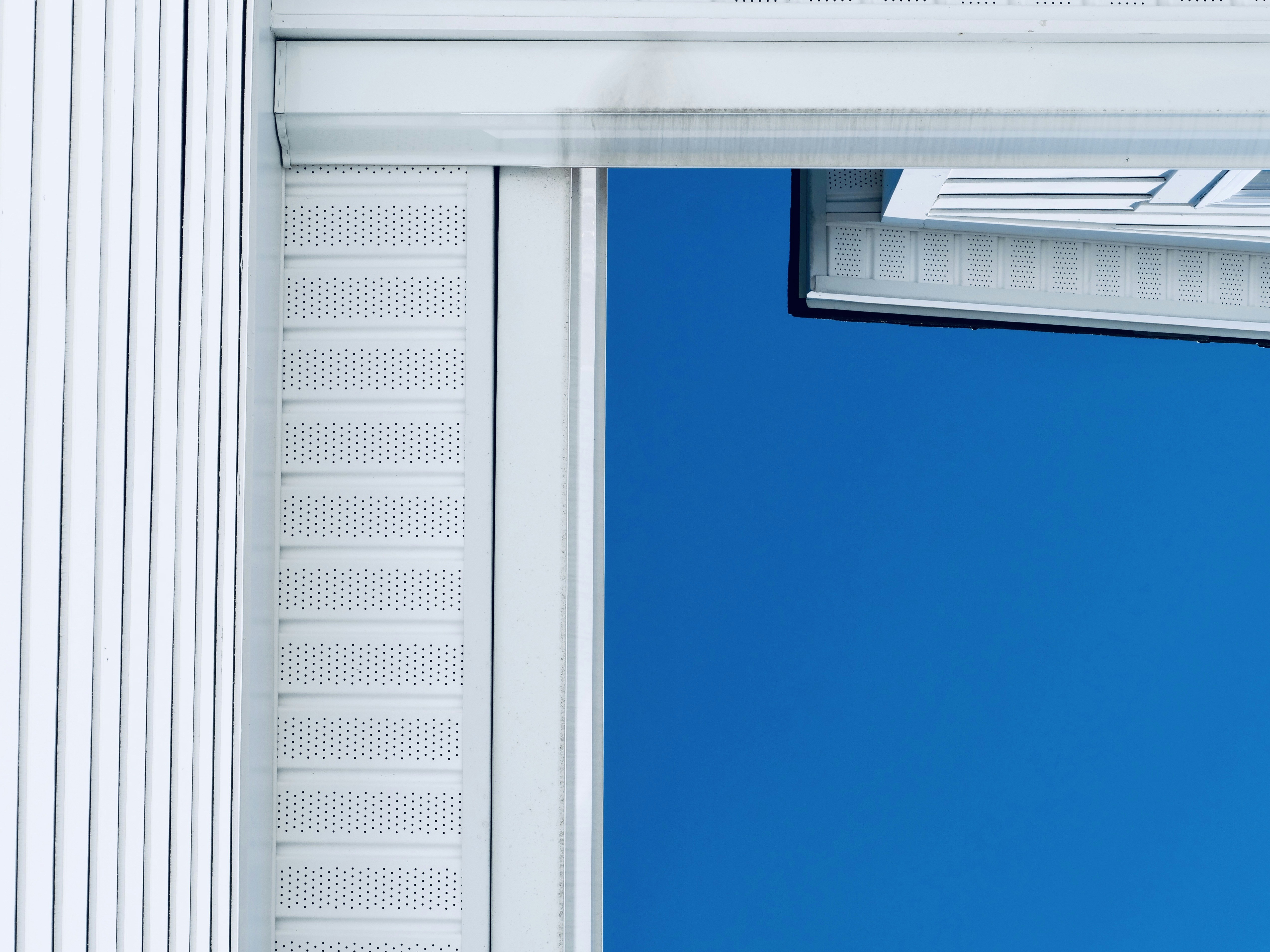 White siding against a bright blue sky