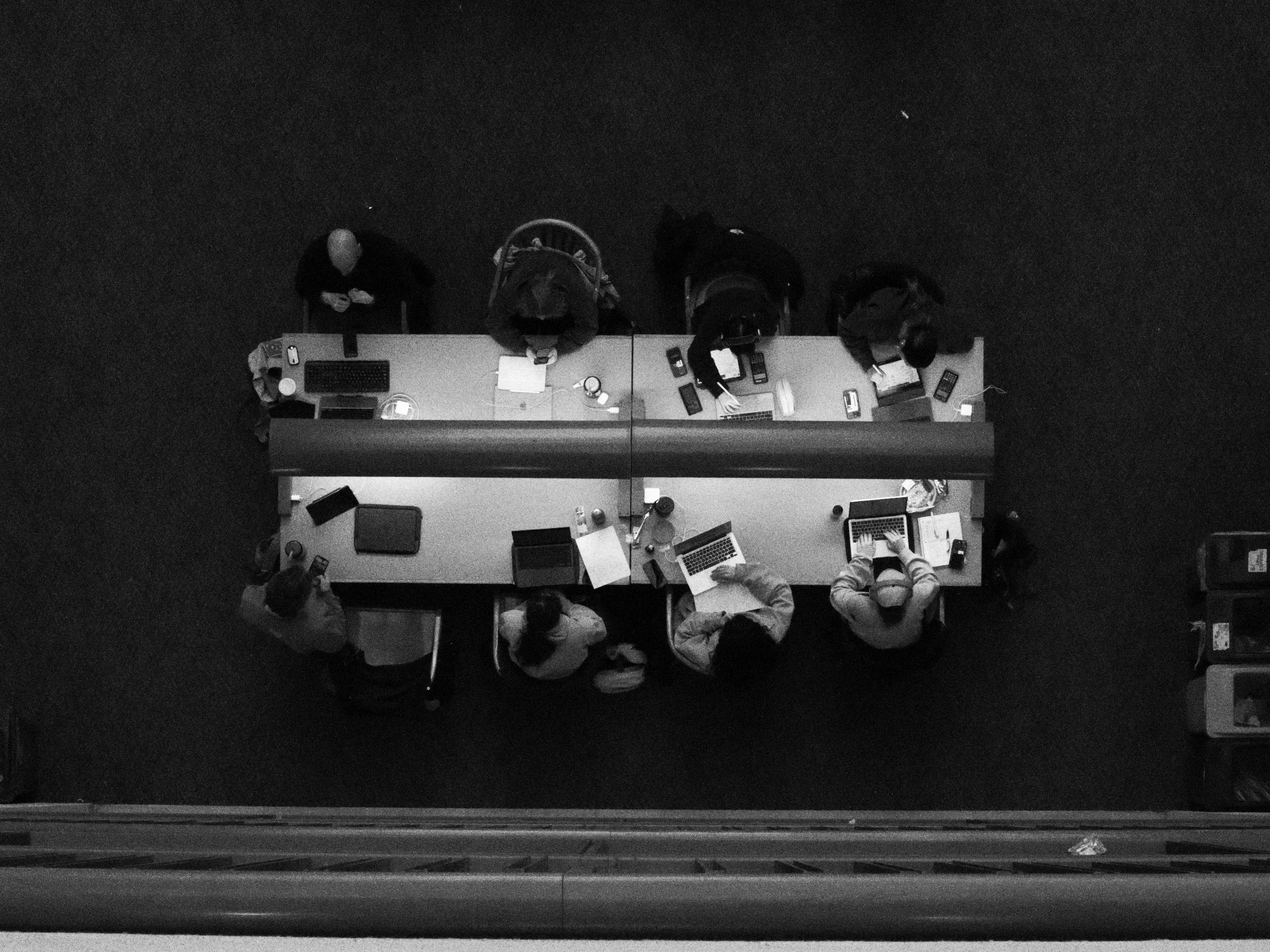 People working at a long table with laptops