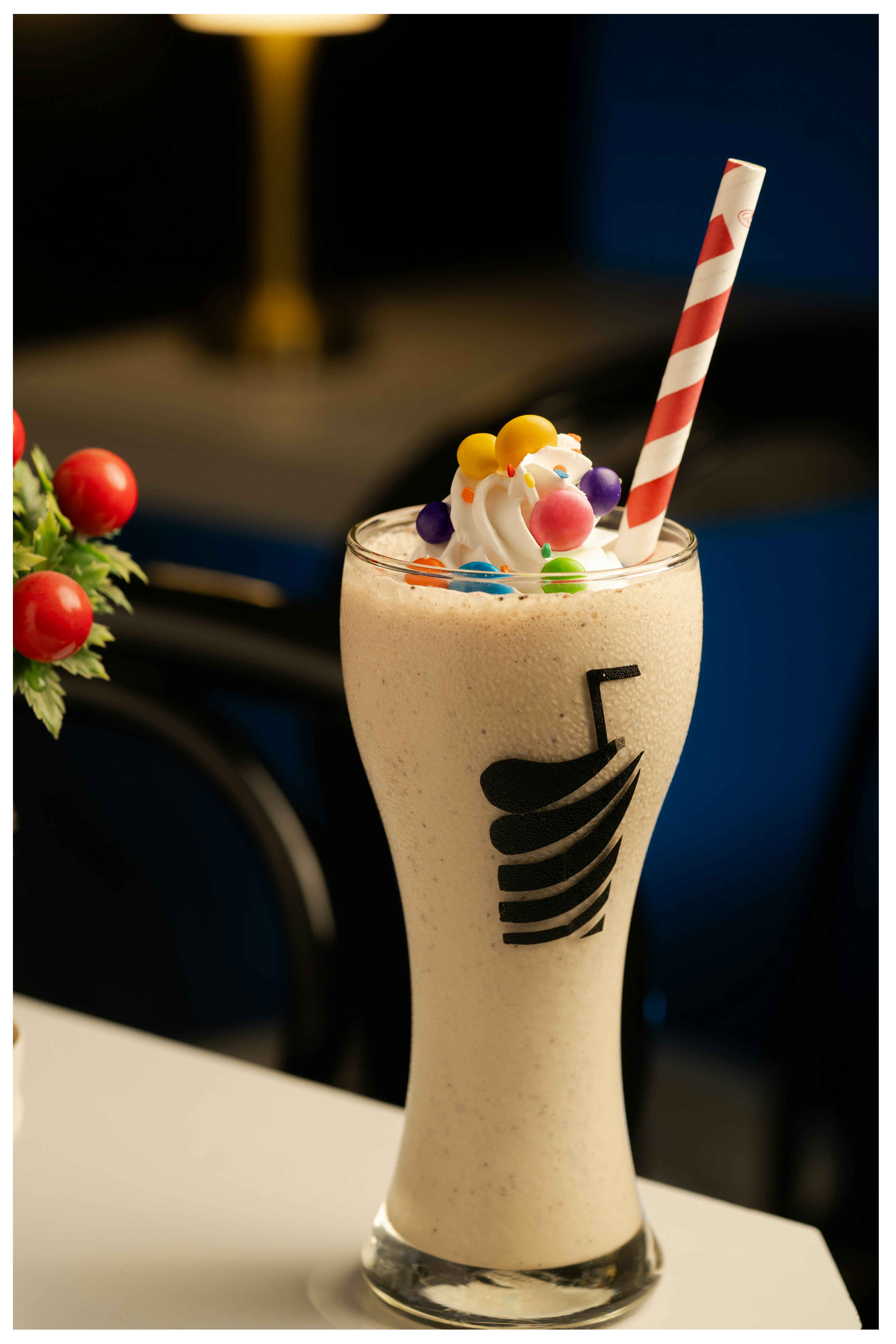A milkshake topped with whipped cream and candy