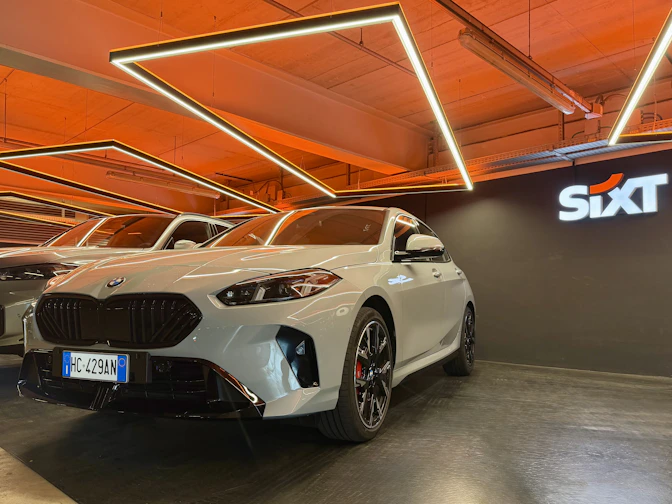 White BMW parked indoors with sixt logo