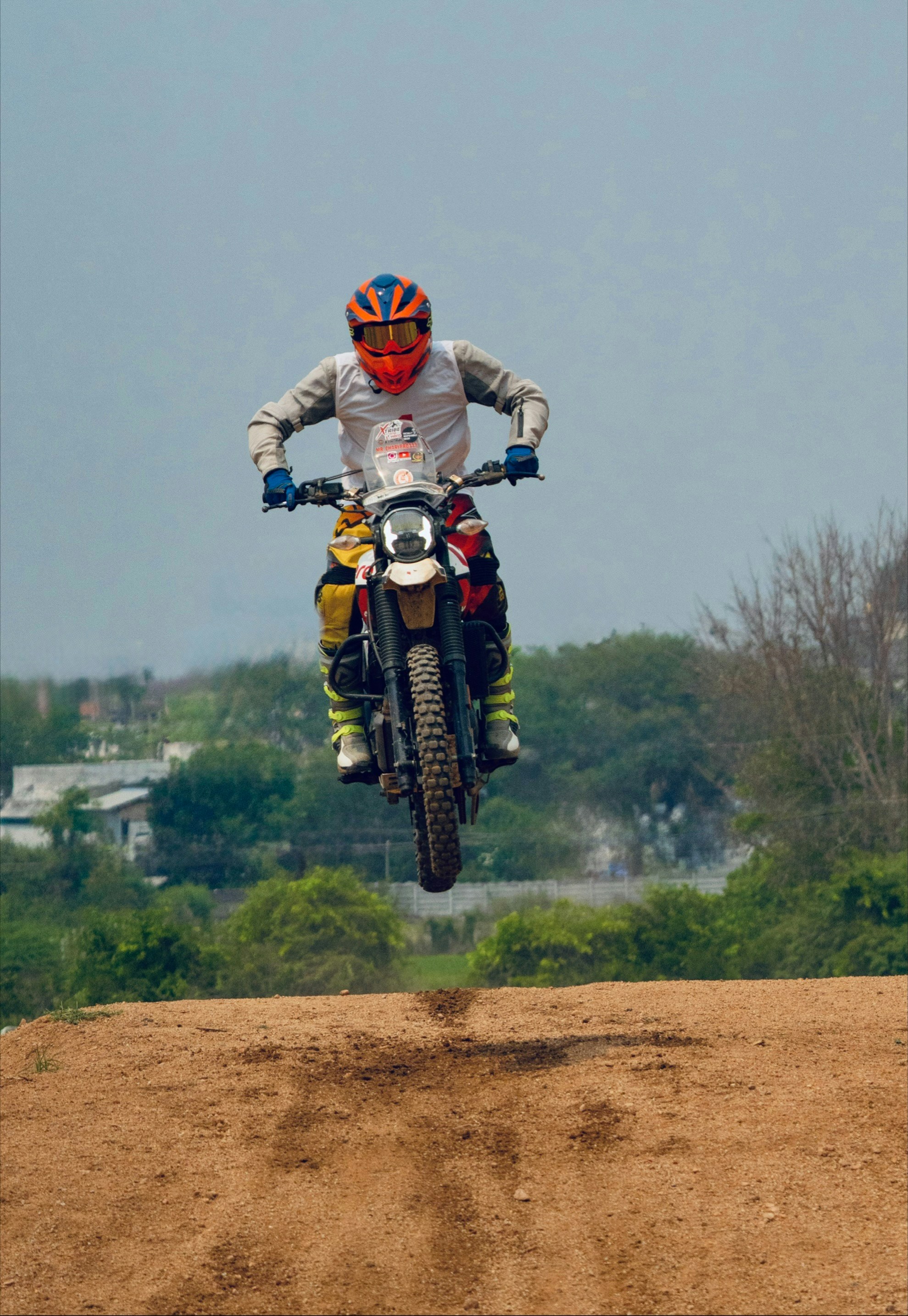 Motorcyclist in mid-air performing a jump.