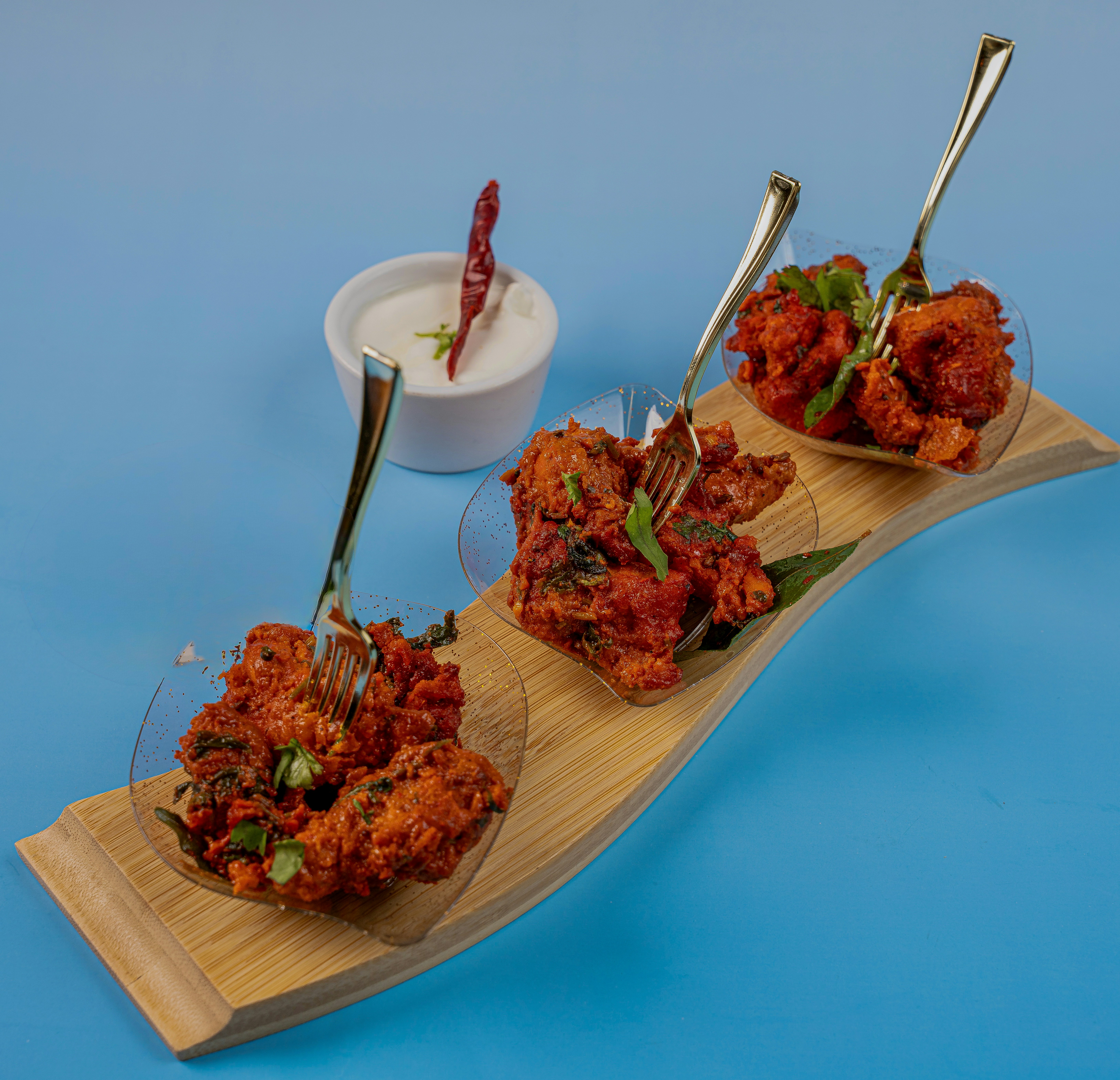 Three servings of spicy fried appetizers with dipping sauce