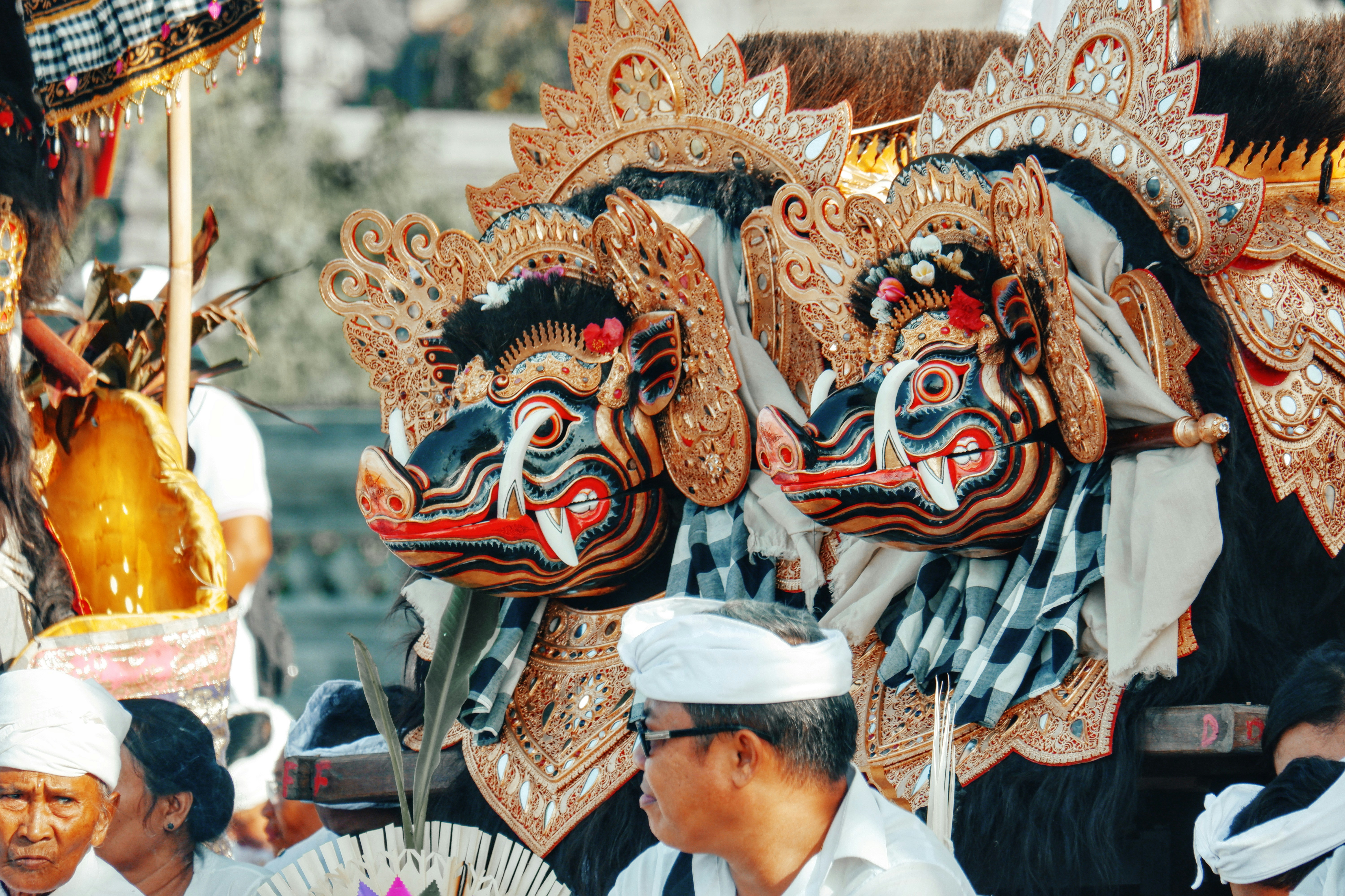 Two ornate dragon masks at a cultural festival.