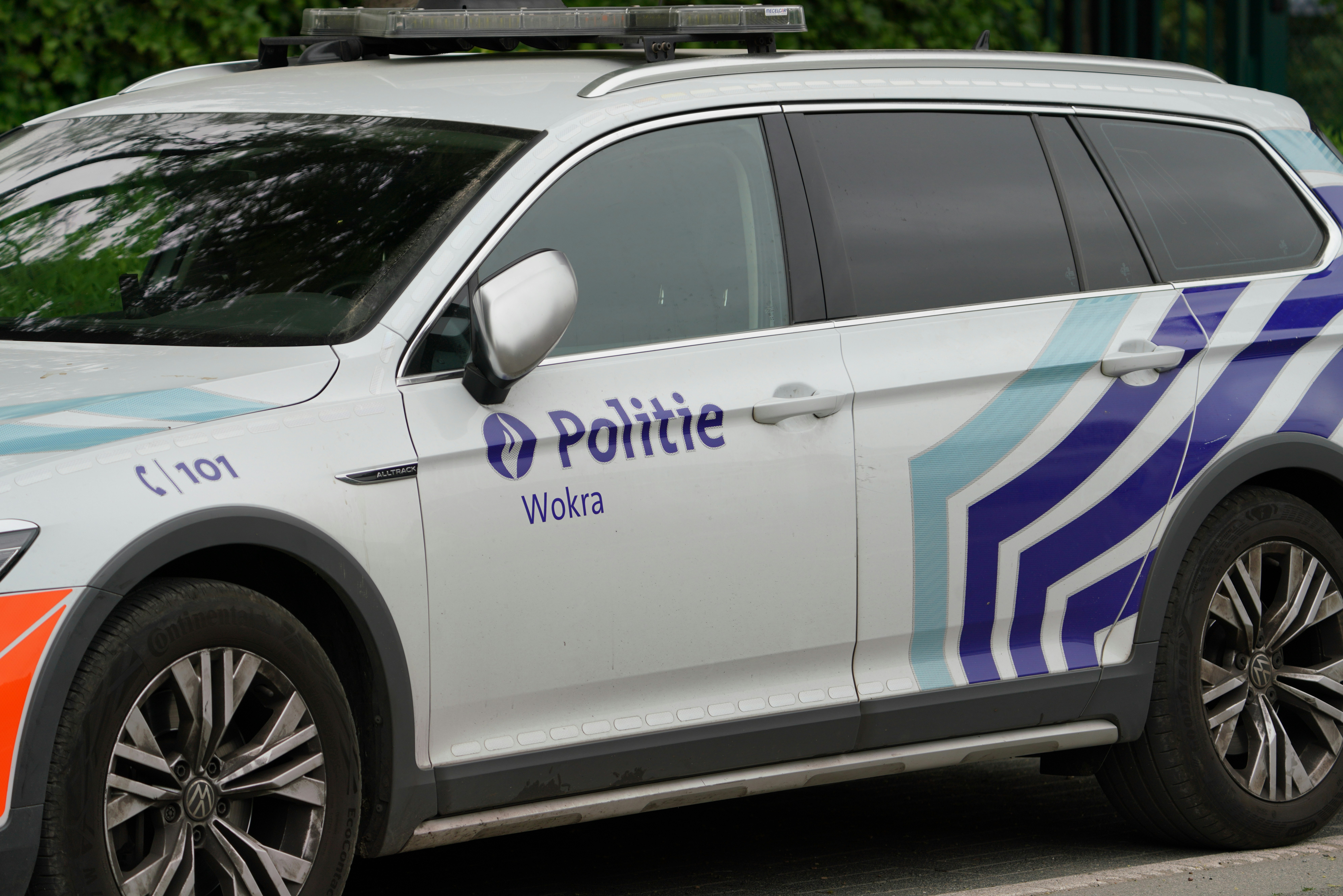 A white police car with blue stripes