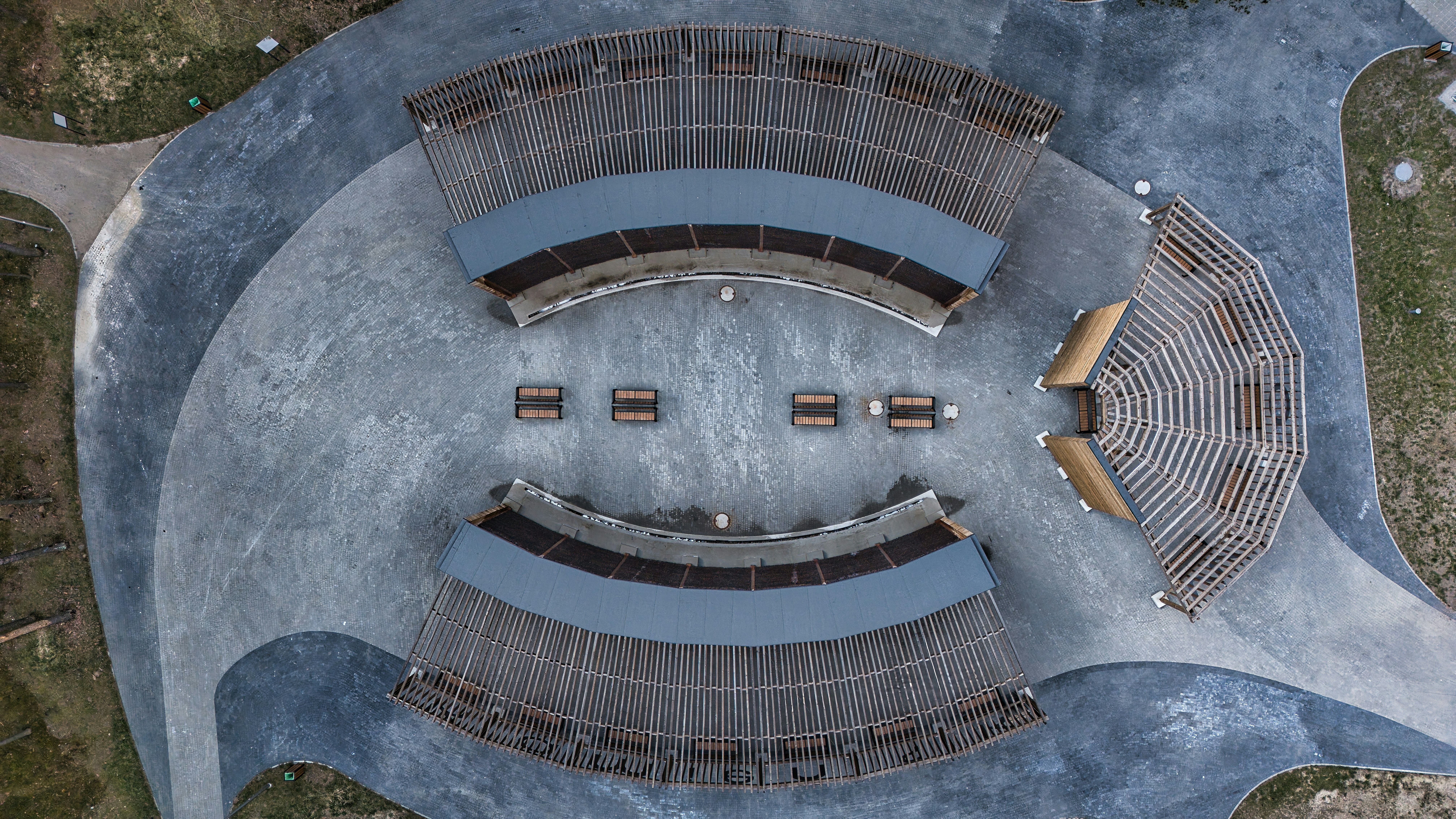 Aerial view of an outdoor amphitheater with curved wooden benches ...