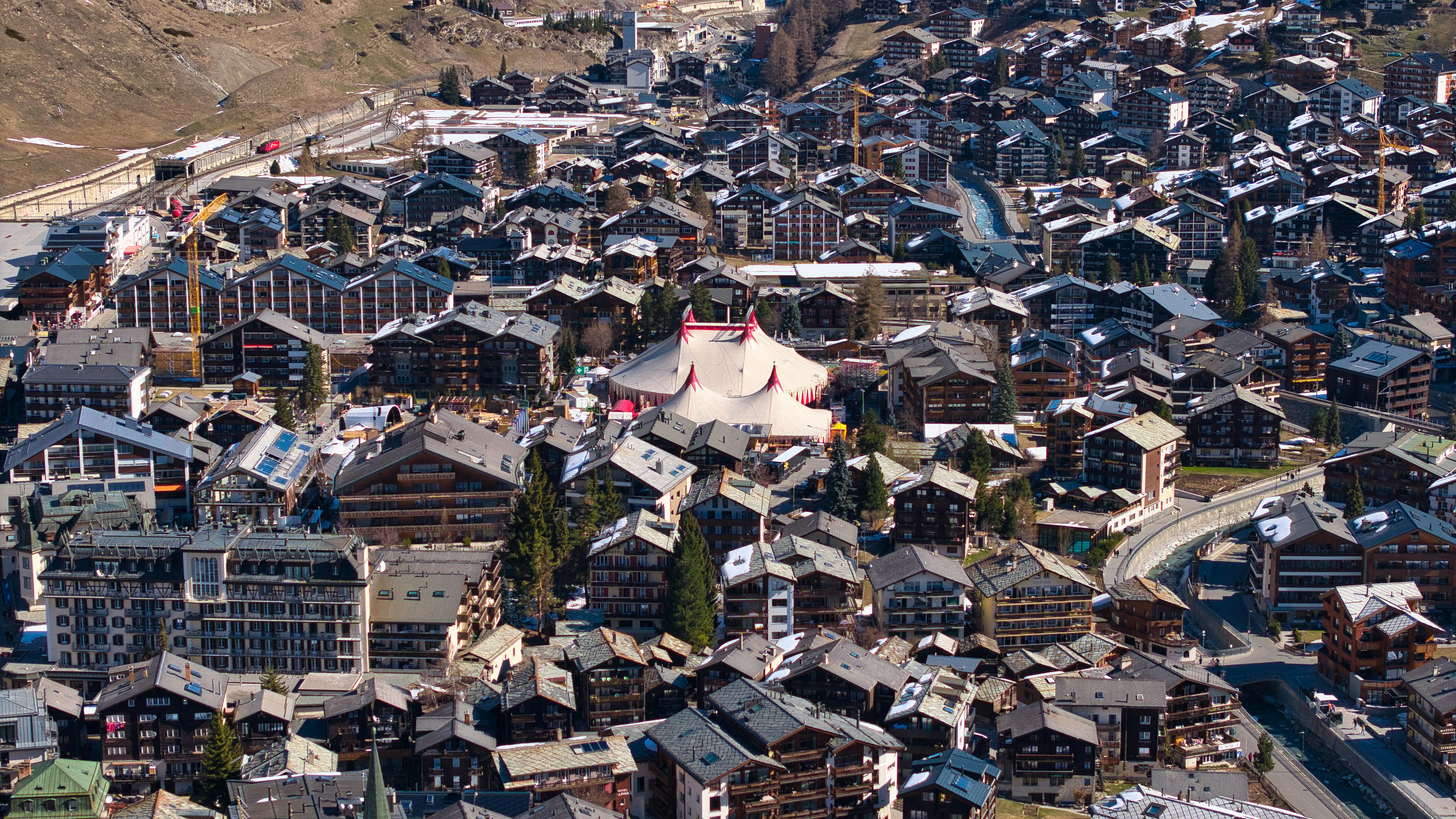 Dense alpine village with traditional wooden chalets.