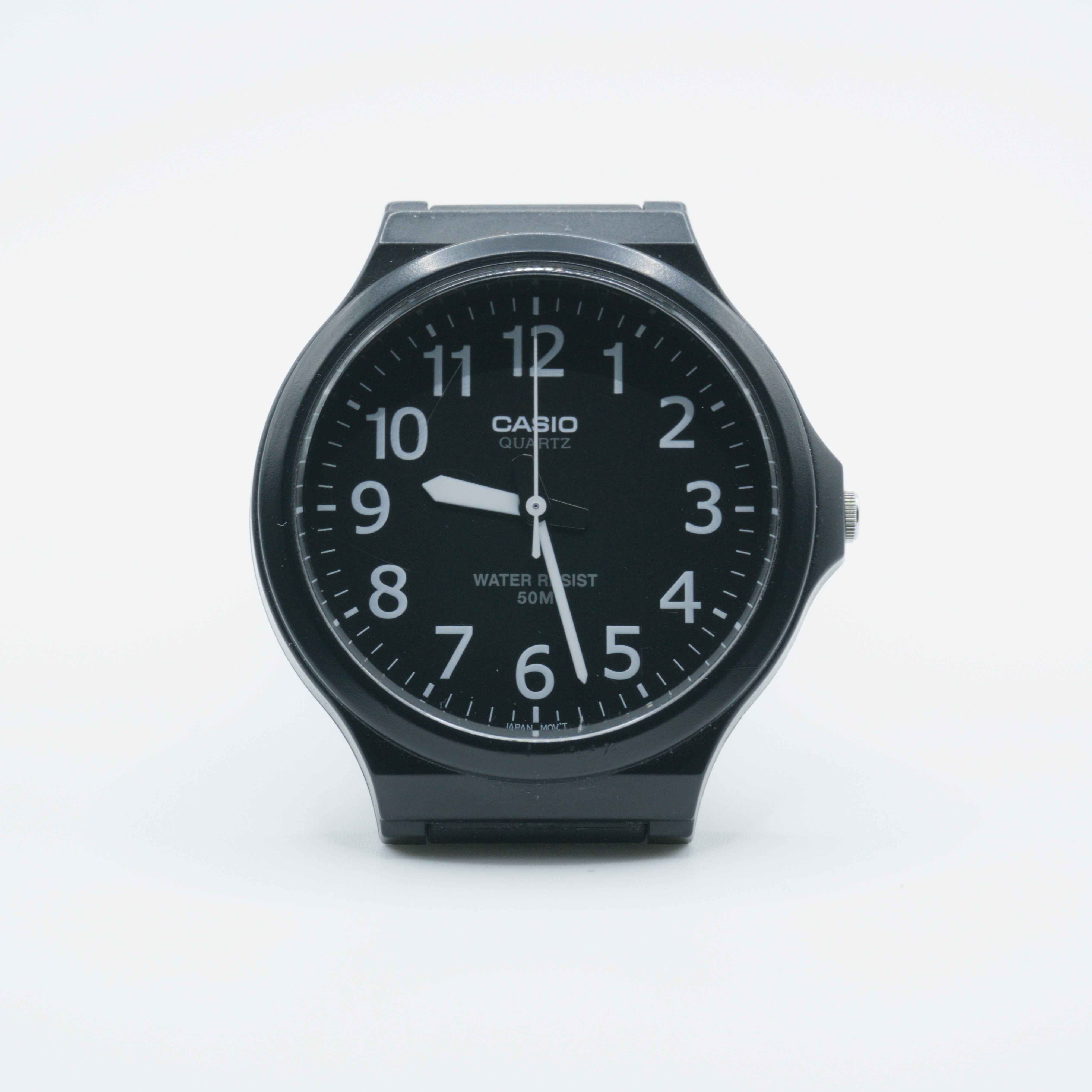 An analogue Casio watch on a clean white surface