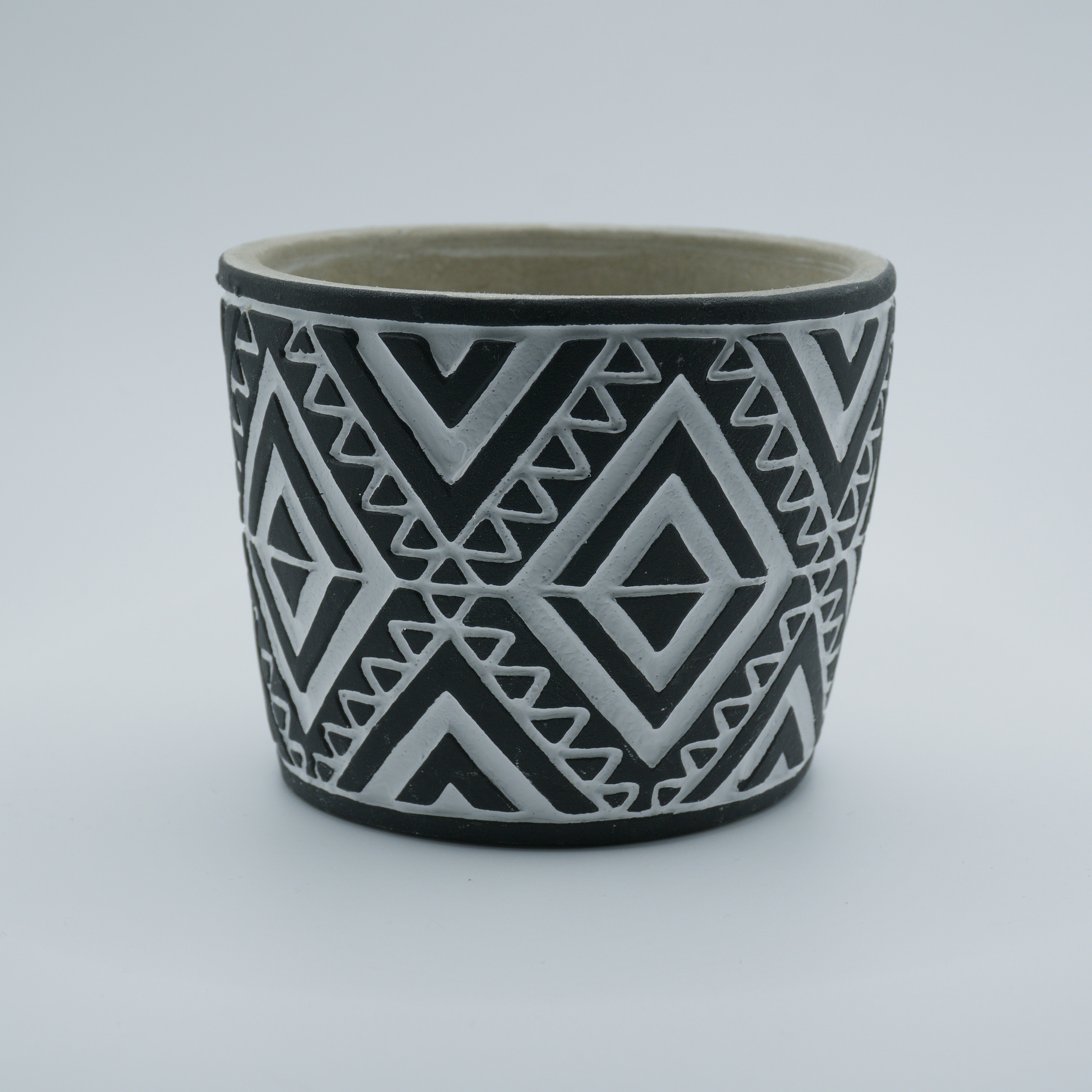 A black and white geometric patterned pot