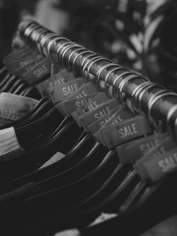 Clothing rack with sale tags in black and white.