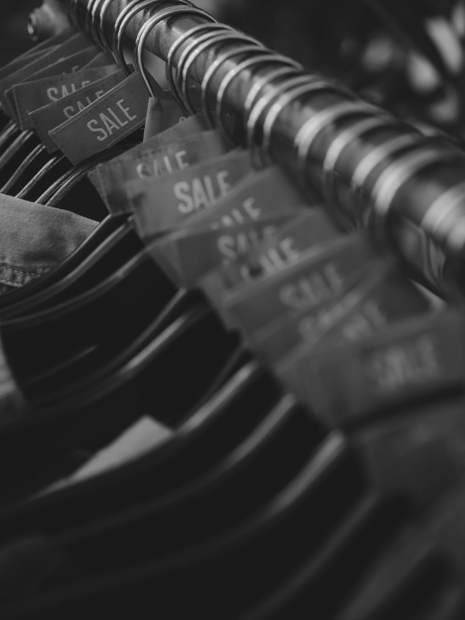 Row of clothing sale tags on hangers