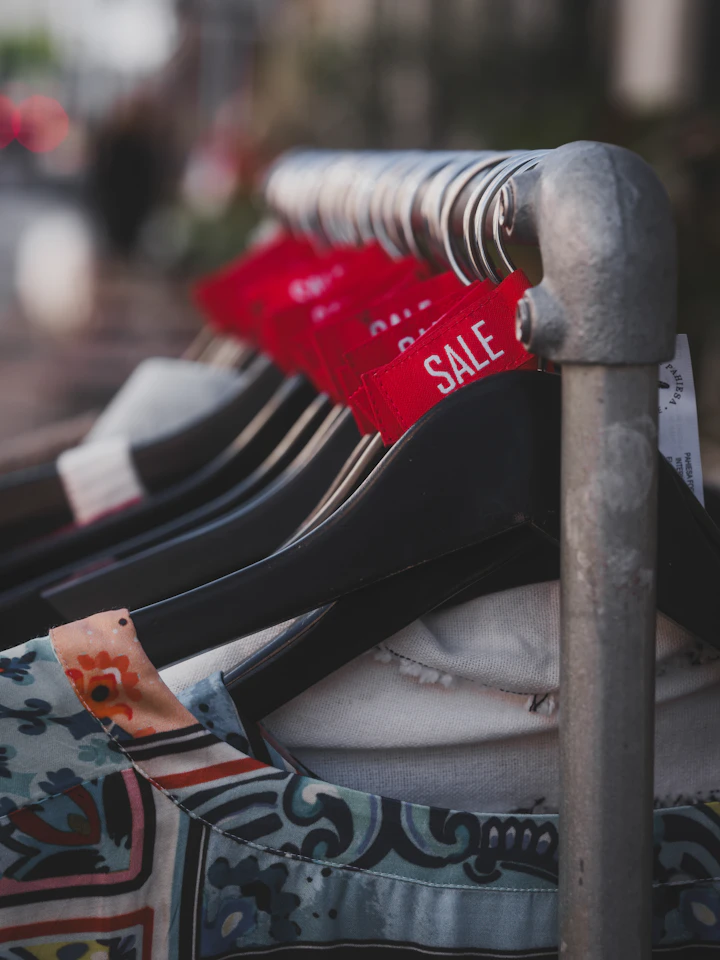 Clothing on hangers with red sale tags