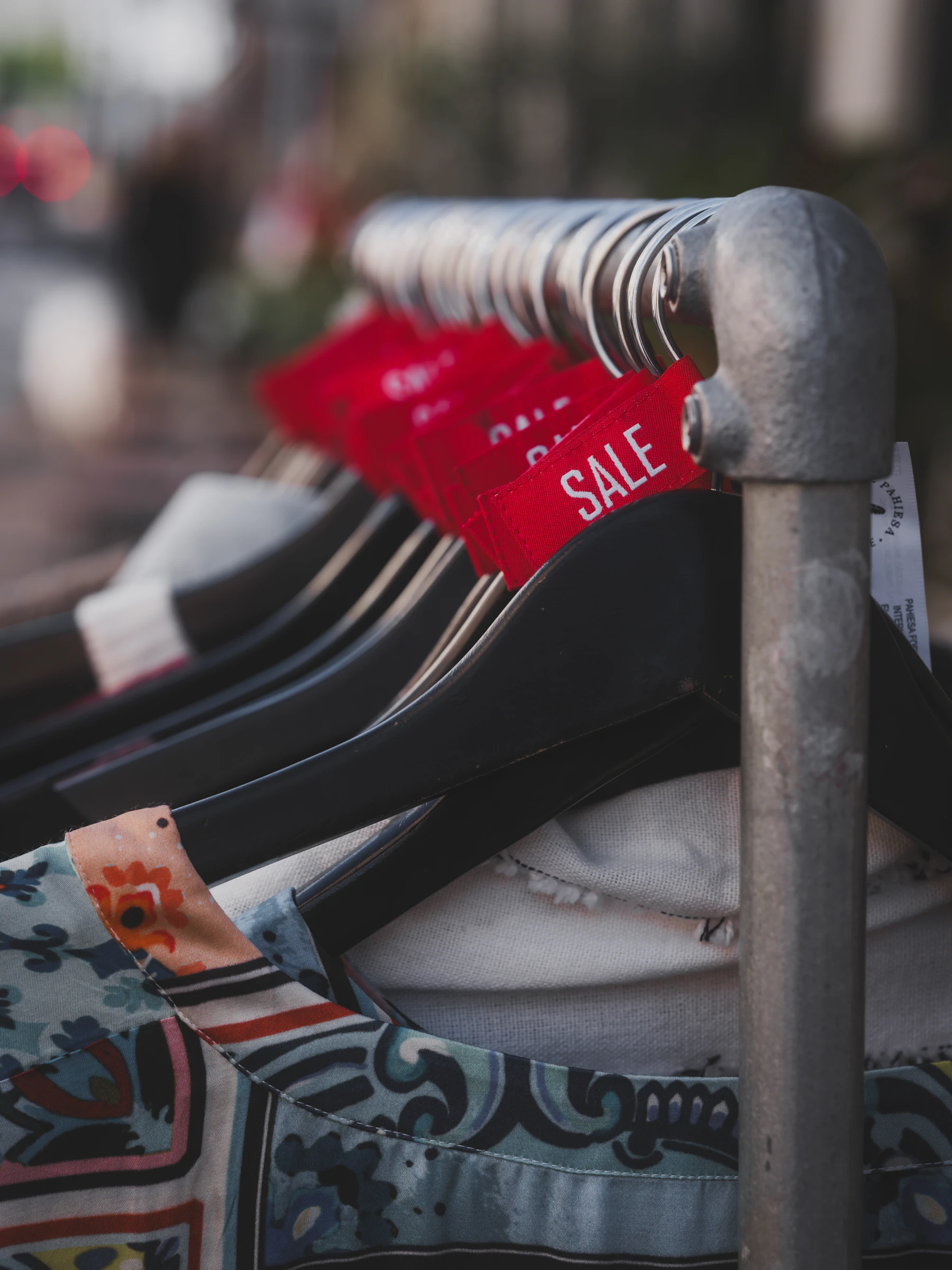 Clothing on hangers with red sale tags