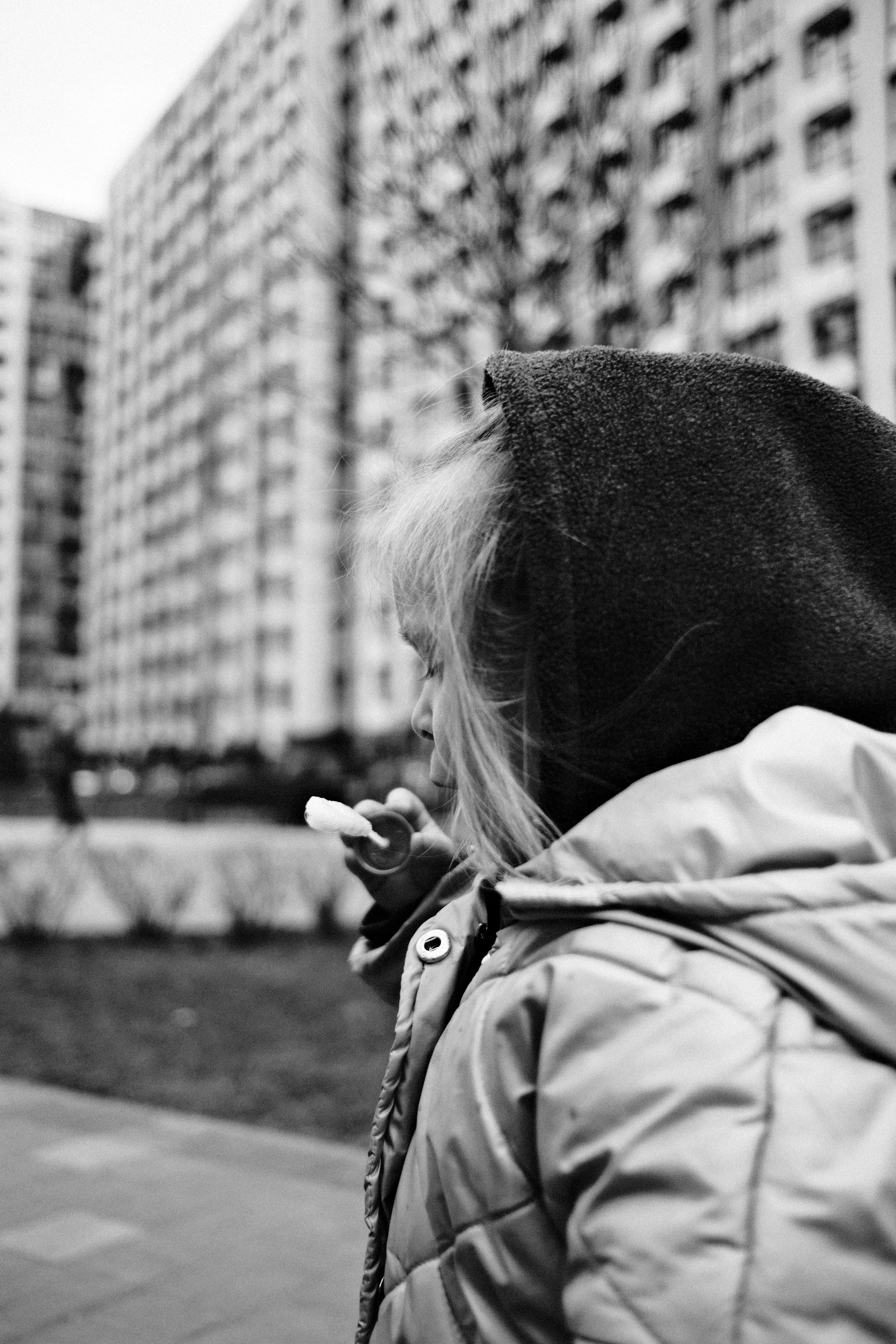 Child in hooded jacket looking away from side
