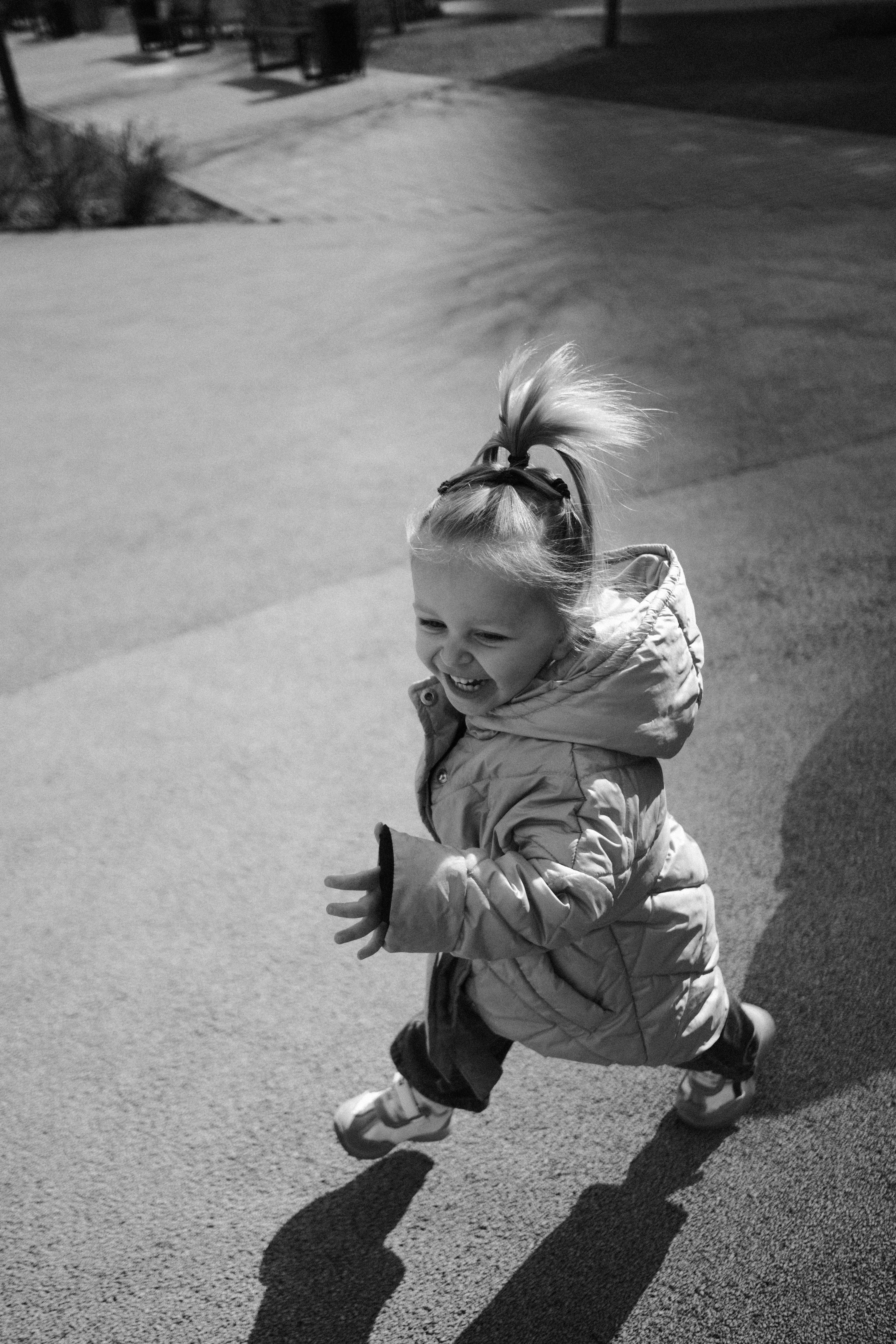 A happy young girl running outdoors in a park