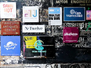 Various signs and posters on a textured wall