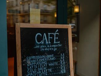 Chalkboard menu outside a french cafe with coffee prices