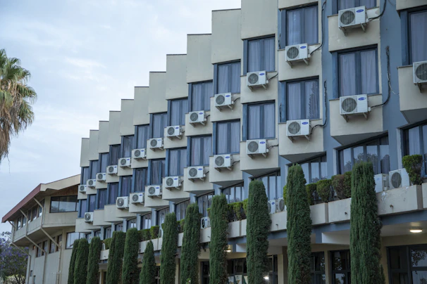 Modern building exterior with many air conditioning units.