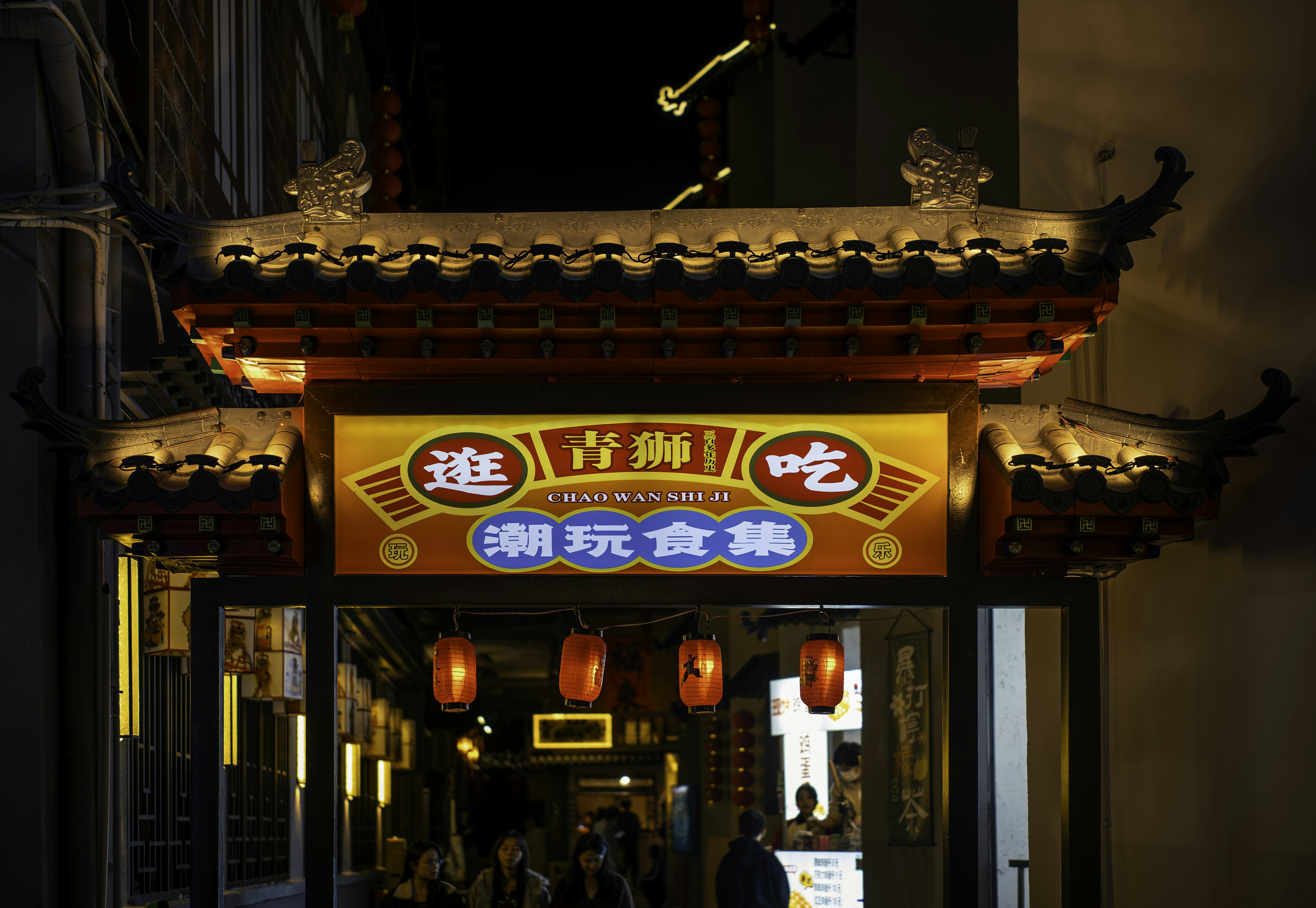 Ornate illuminated archway with chinese characters at night