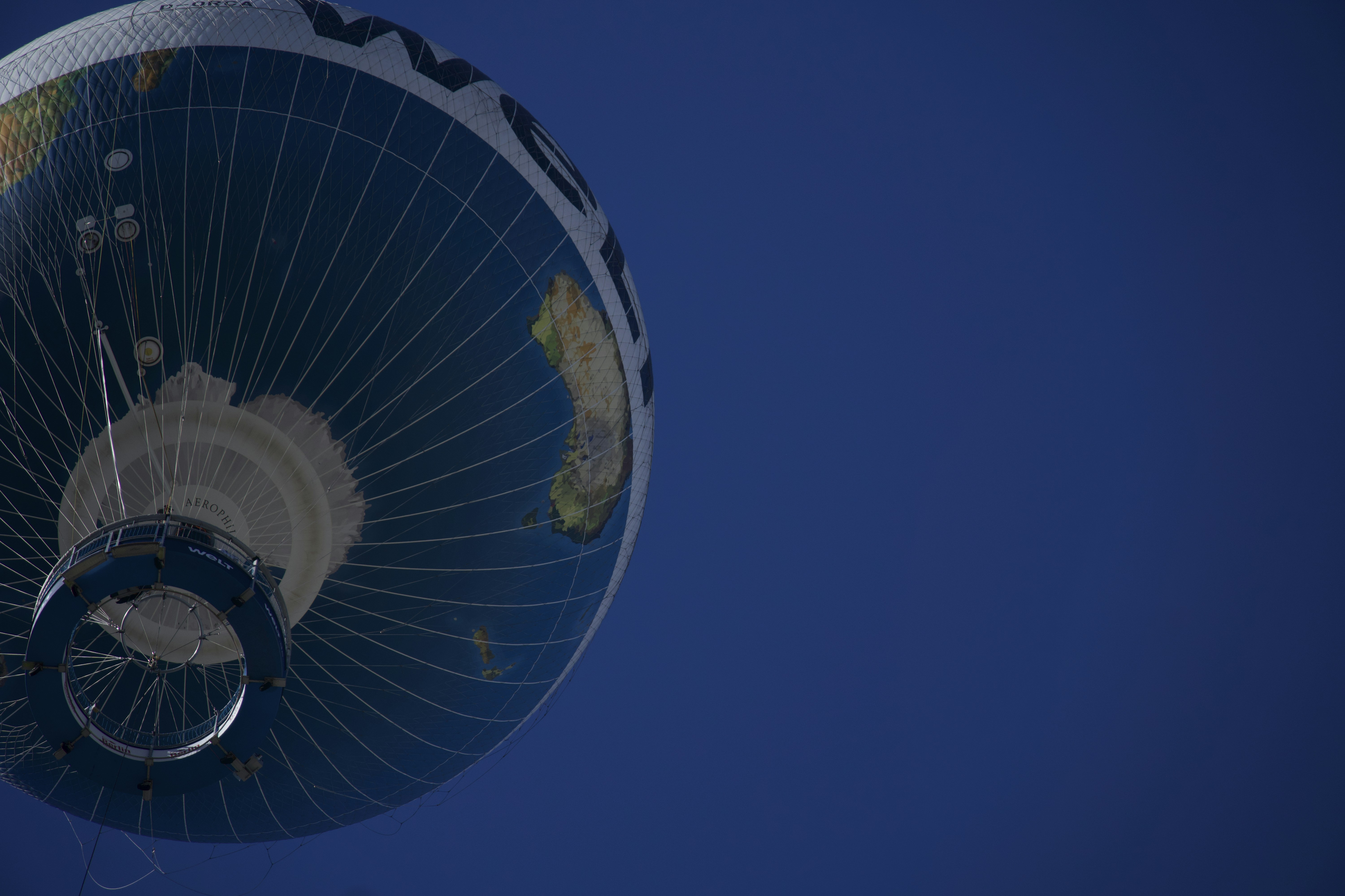 Hot air balloon with earth design against blue sky
