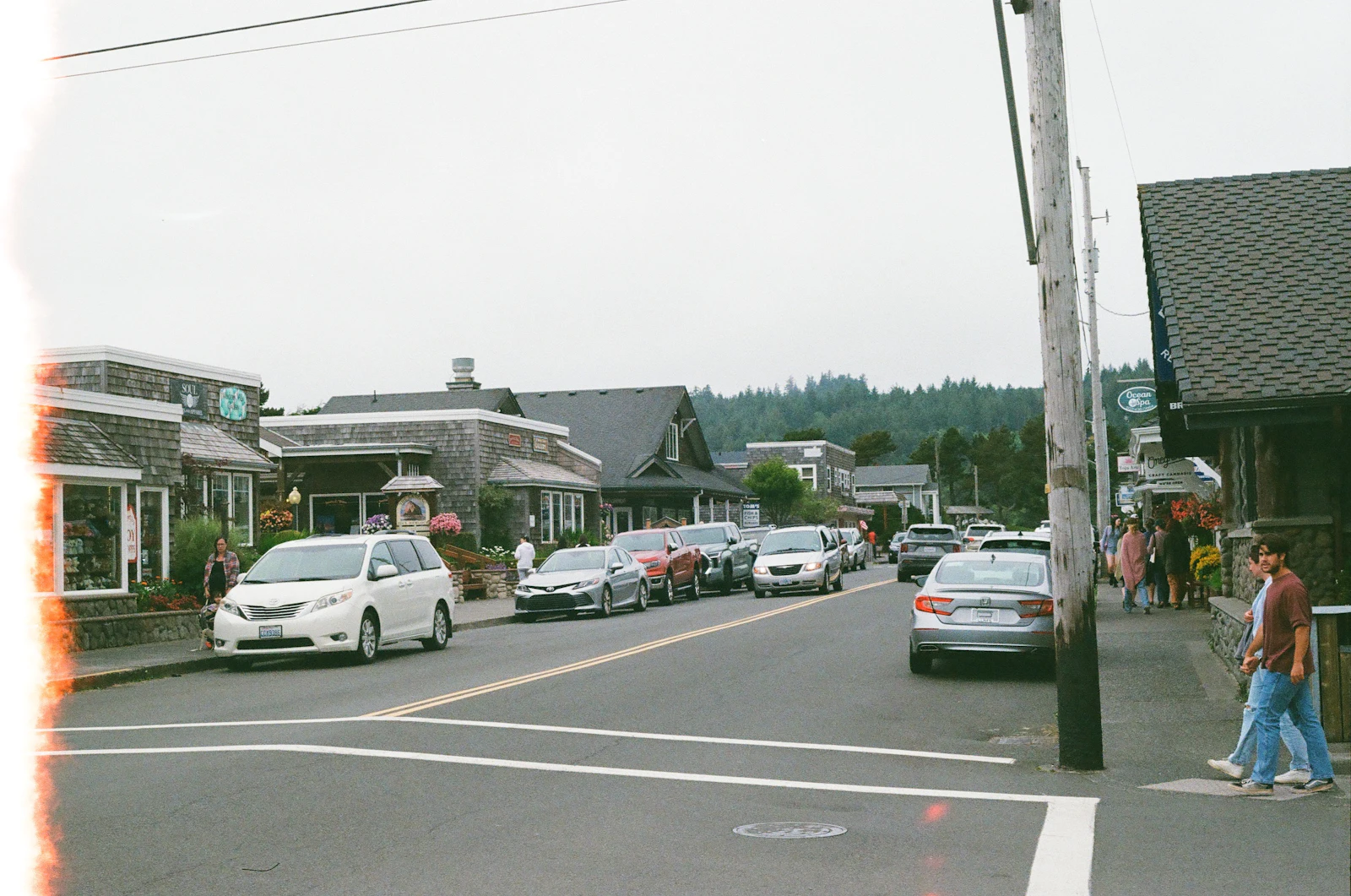 Shops and parked cars along a small-city main street.