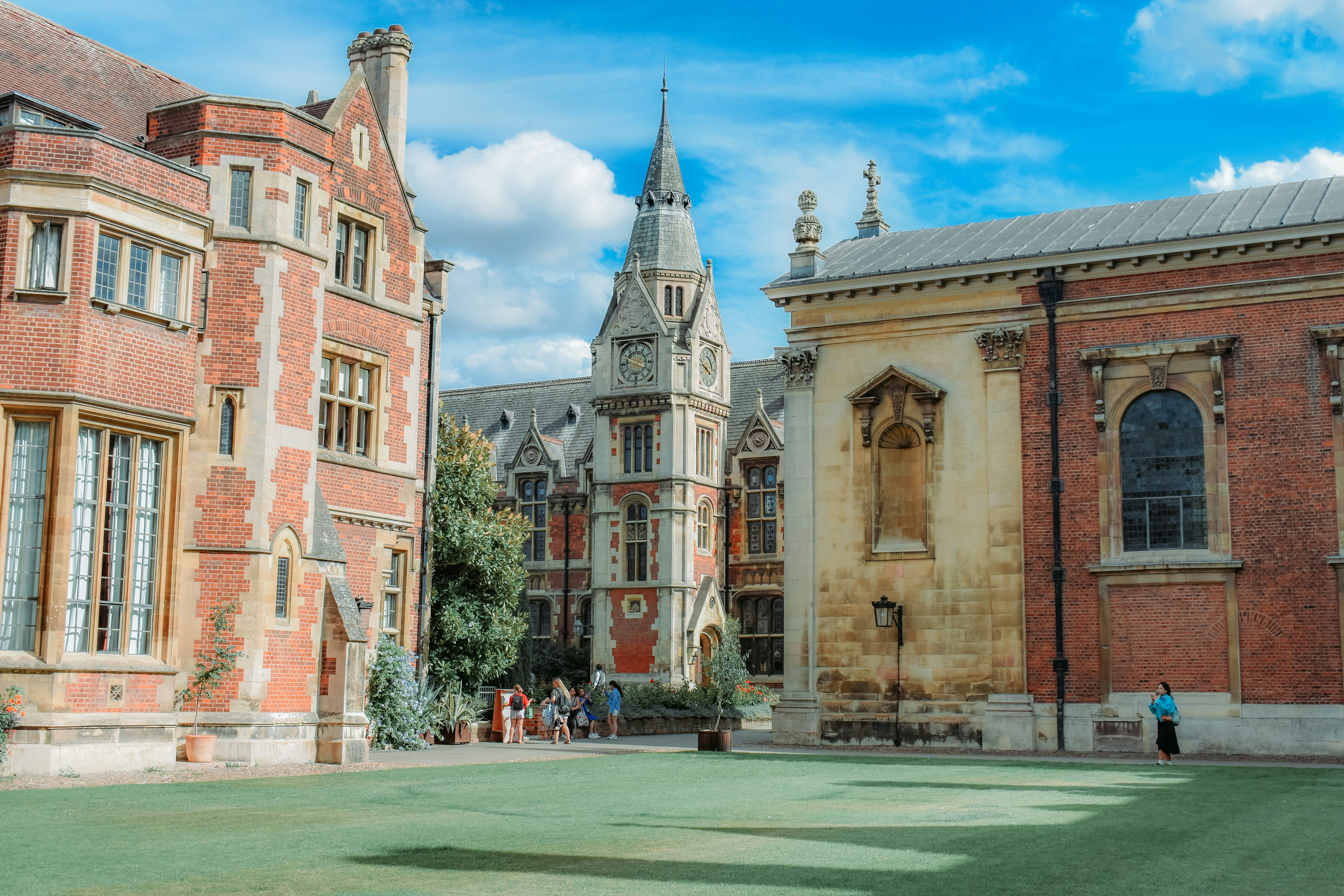 Courtyard of historic brick buildings under a blue sky