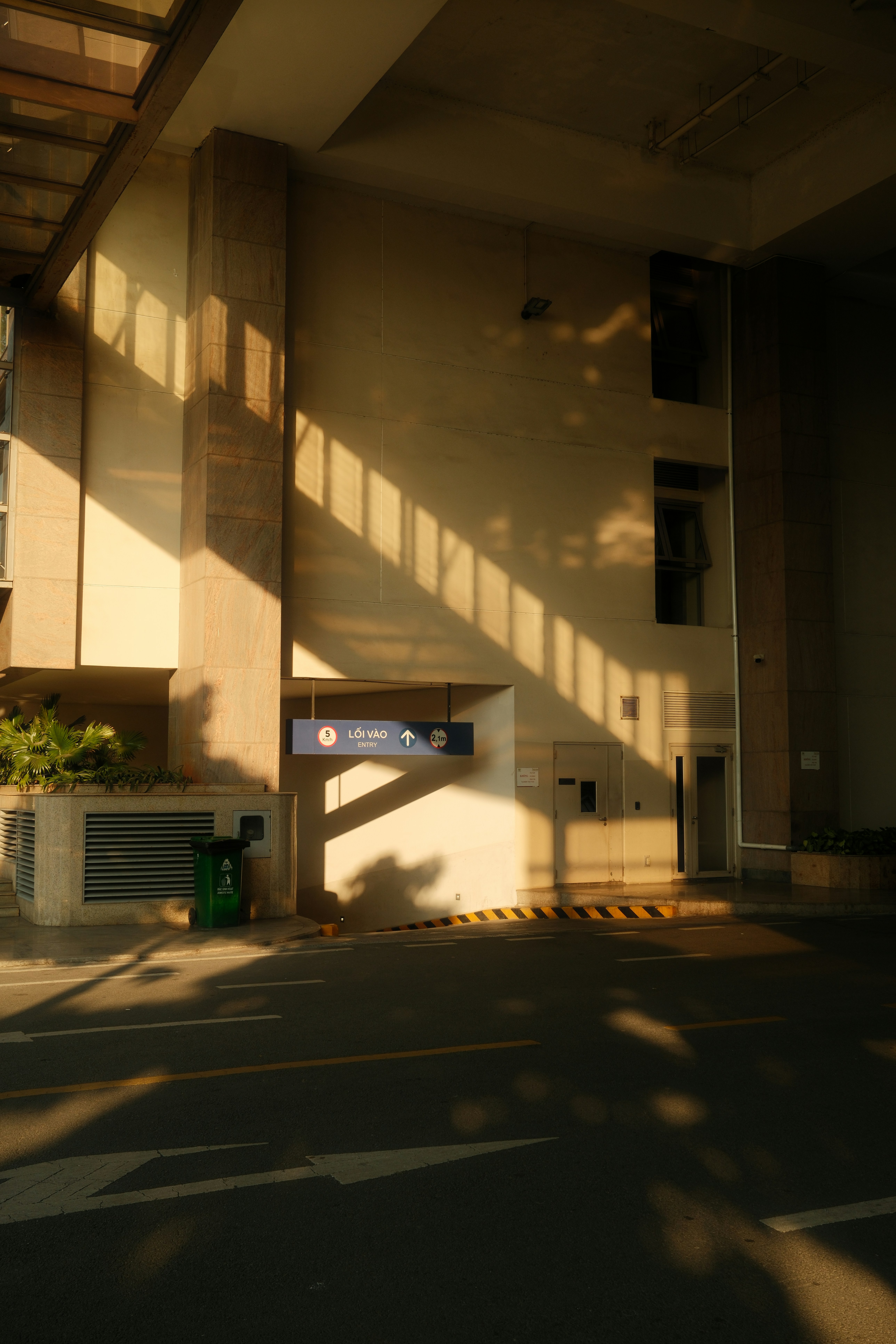 Sunlight casts long shadows on a modern building exterior.