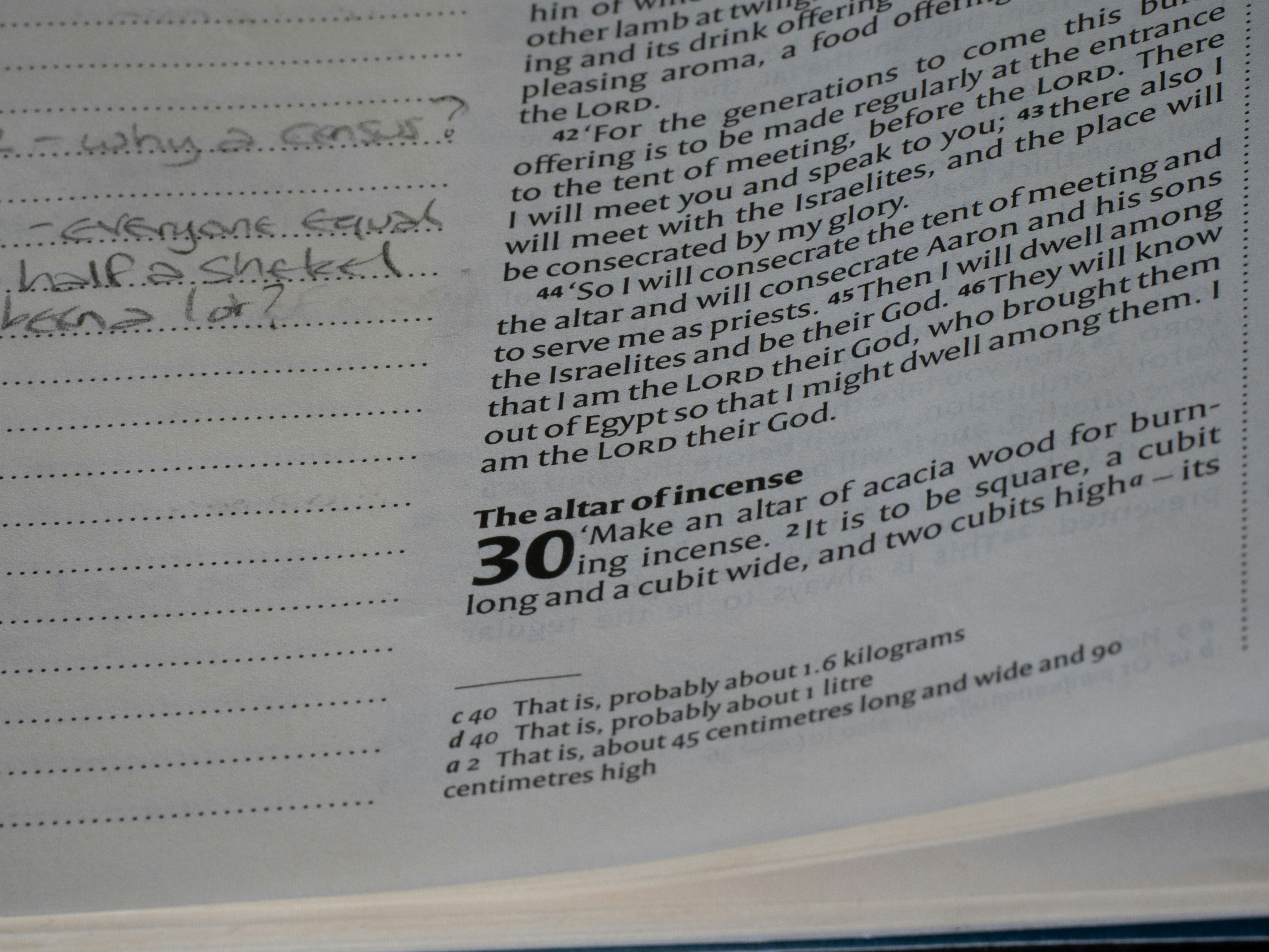 Close-up of text in a book with handwritten notes.