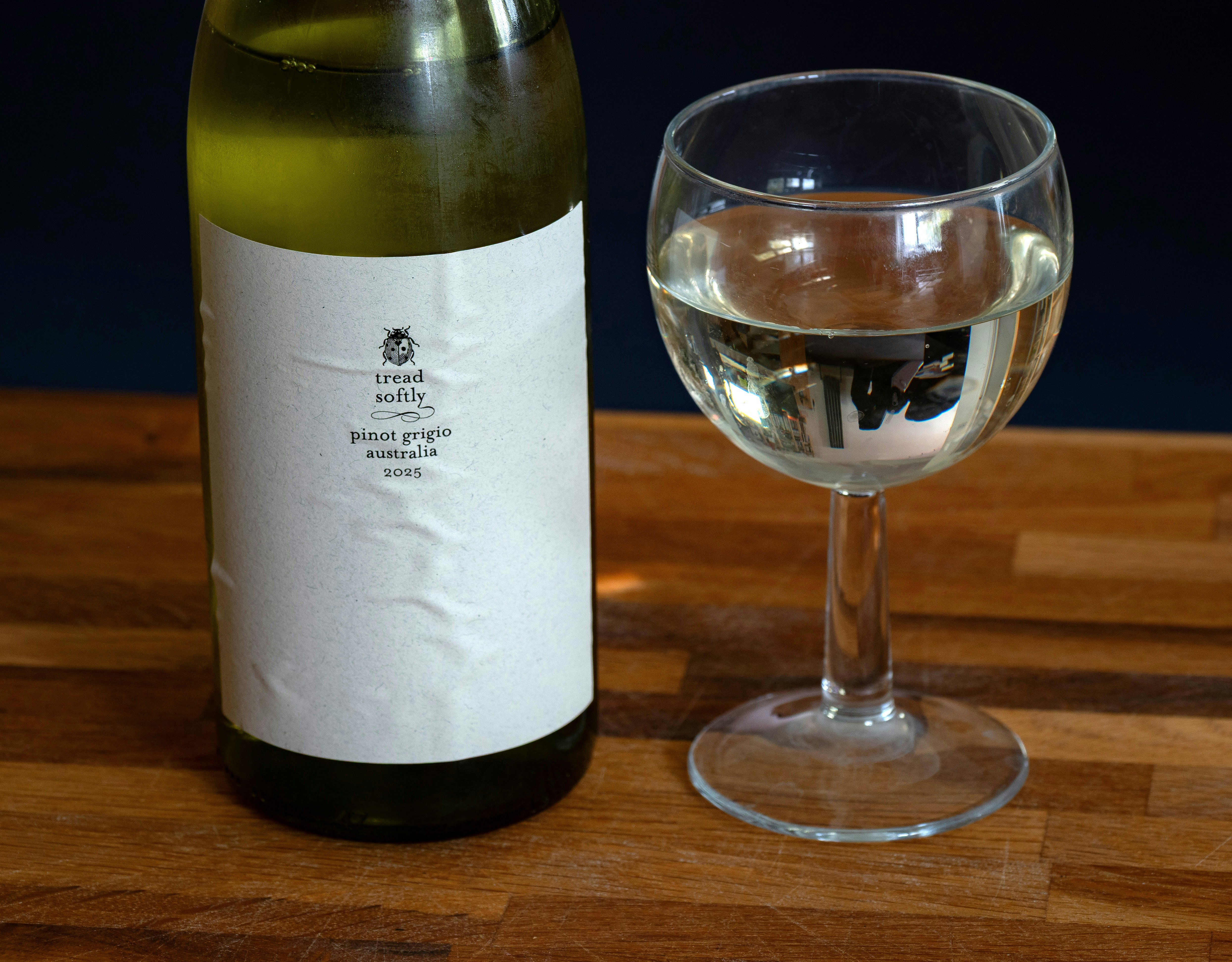 A bottle and glass of white wine