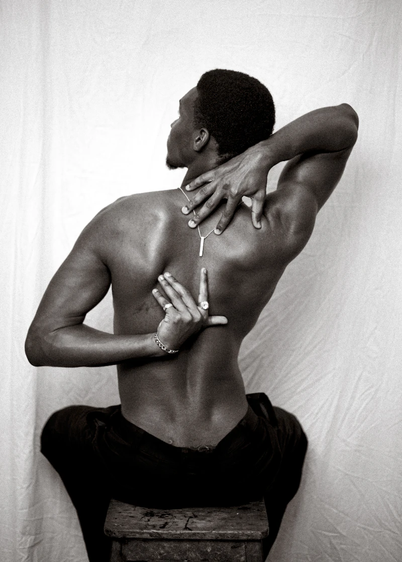 Black African man stretching his back with hands clasped behind him – kidney health Nigeria