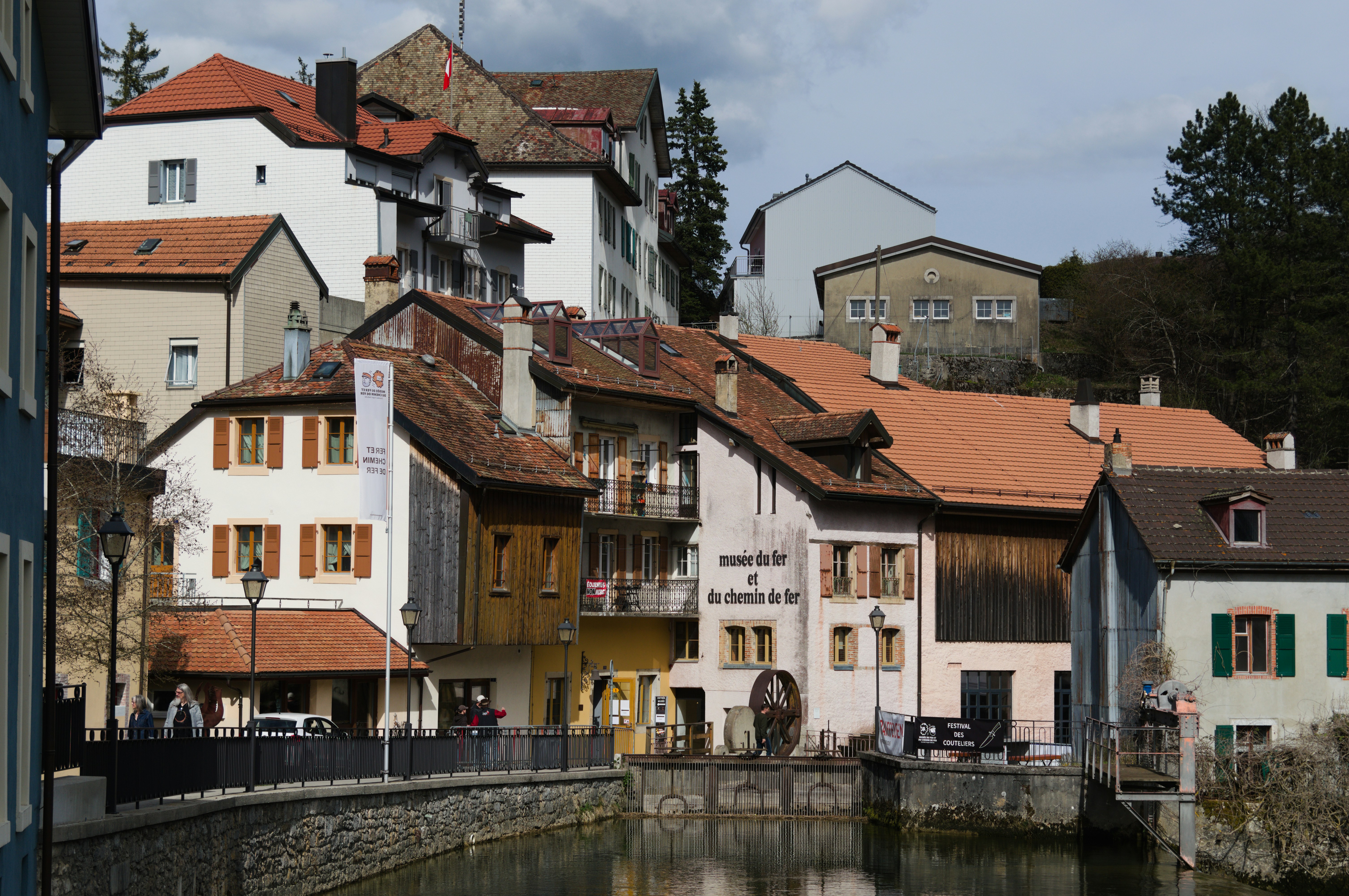 Old european buildings line a calm canal.