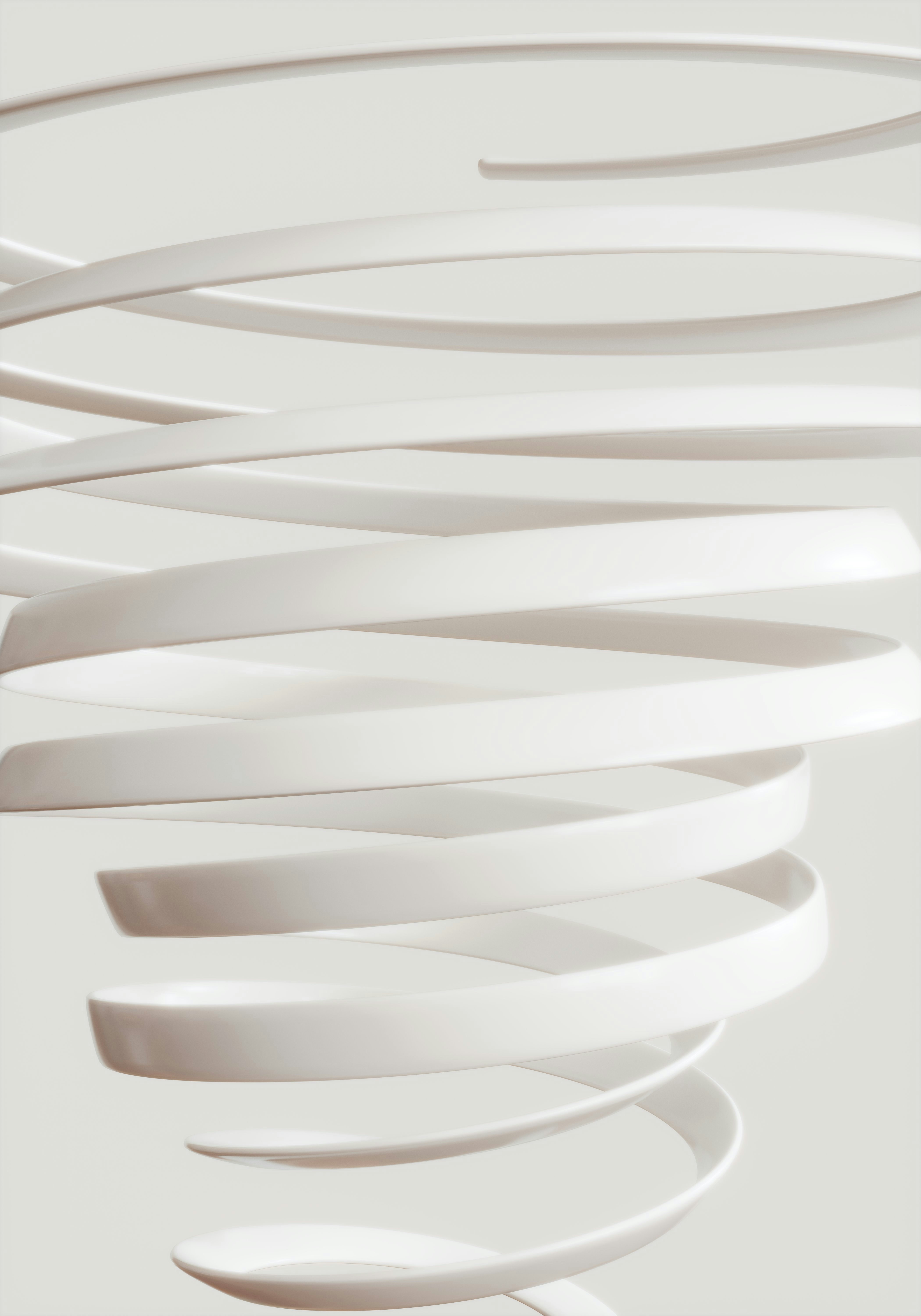 Abstract white spiral shapes against a light background.