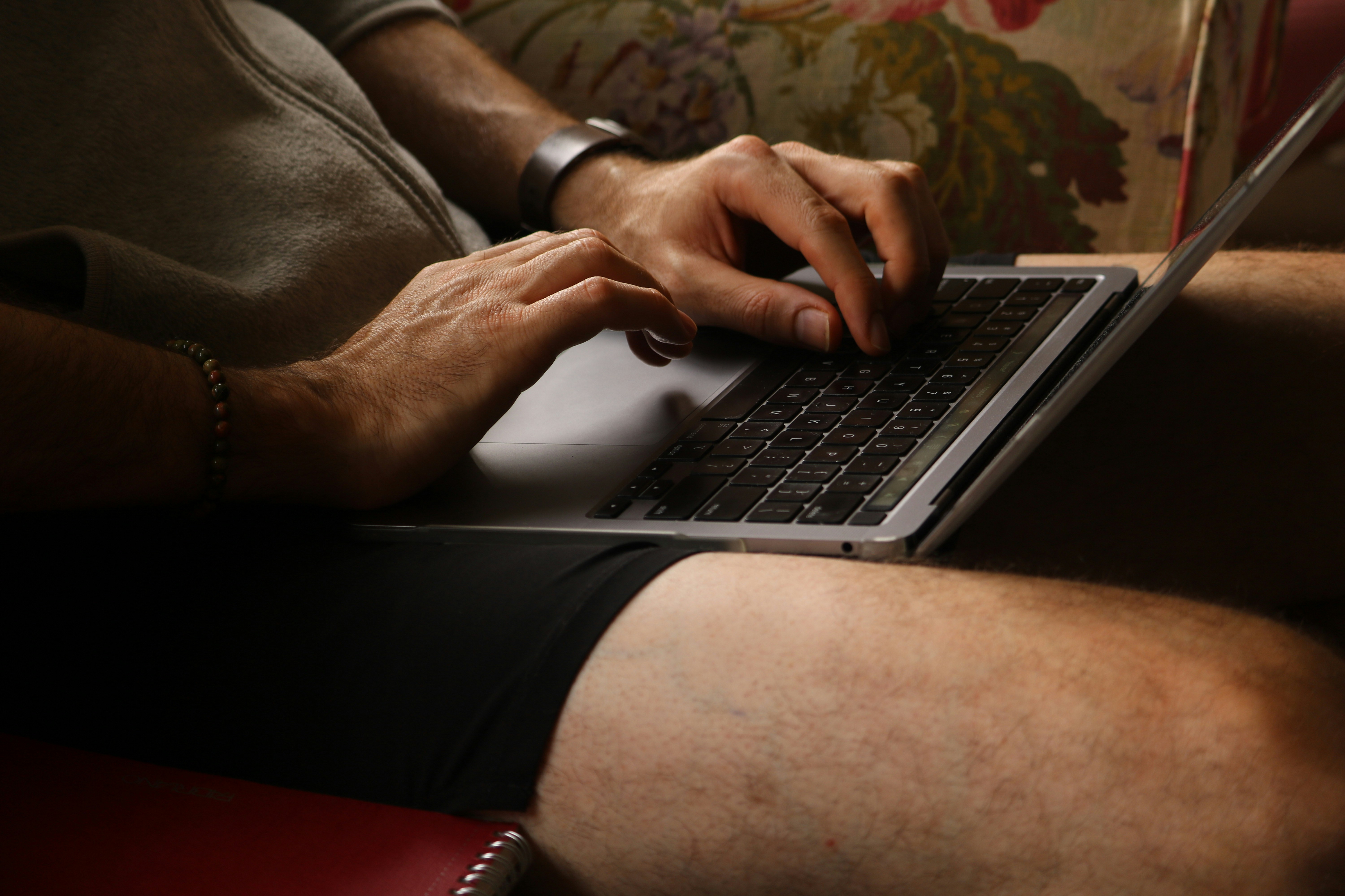 Person typing on a laptop computer indoors