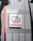 Monaco circuit direction course sign on building