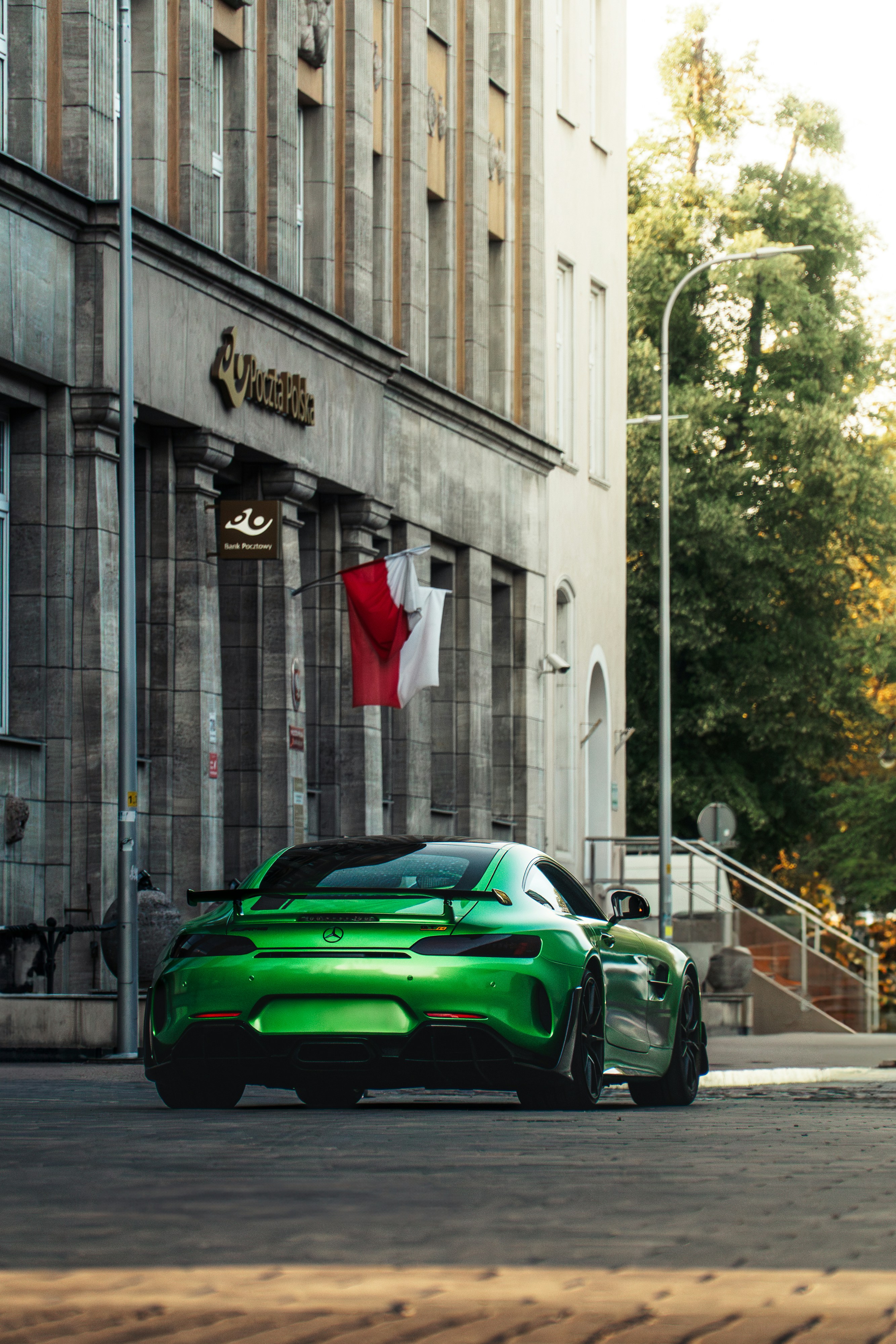 A vibrant green sports car parked on a city street