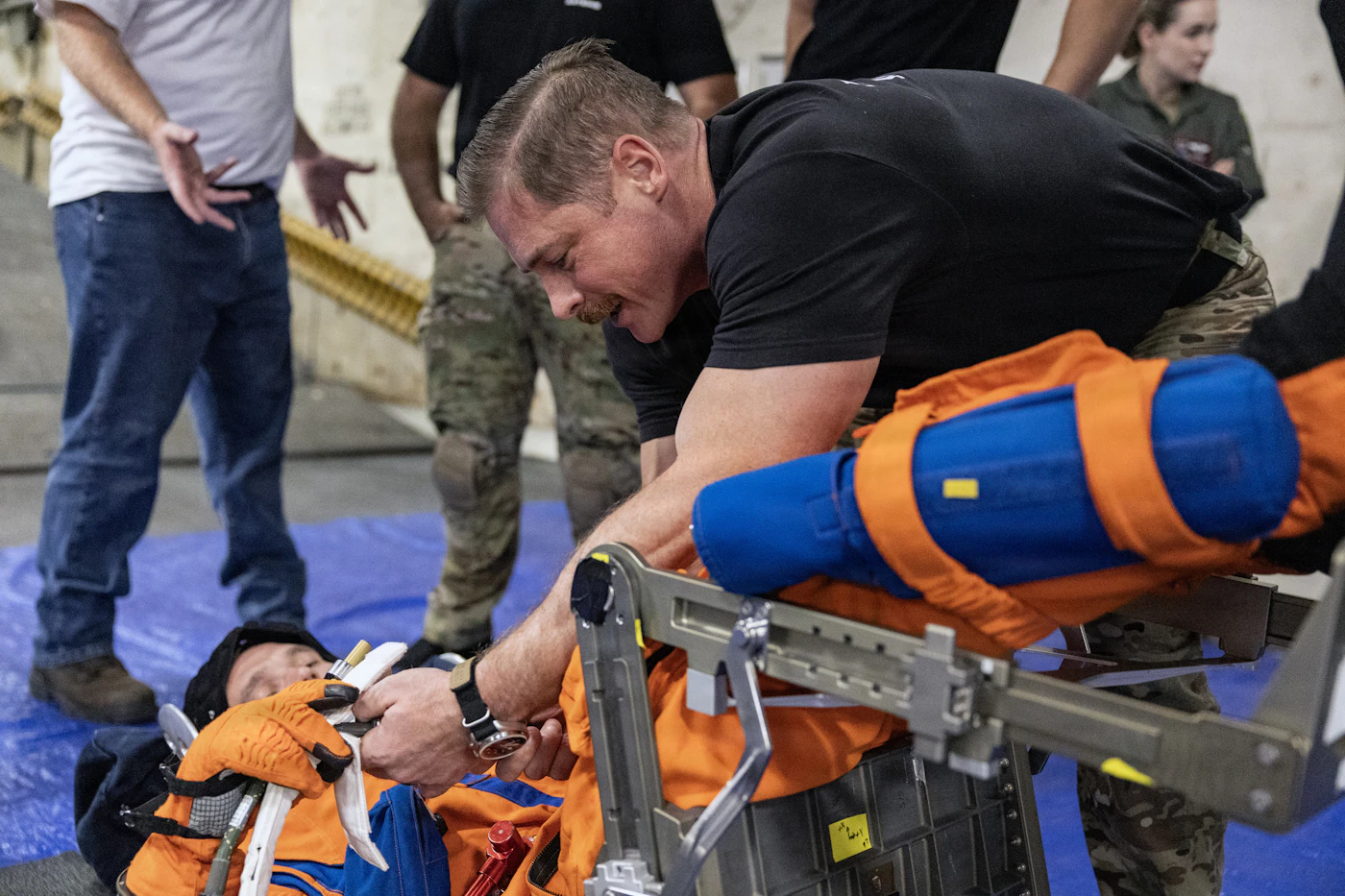 U.S. healthcare professionals stabilizing a patient on a stretcher
